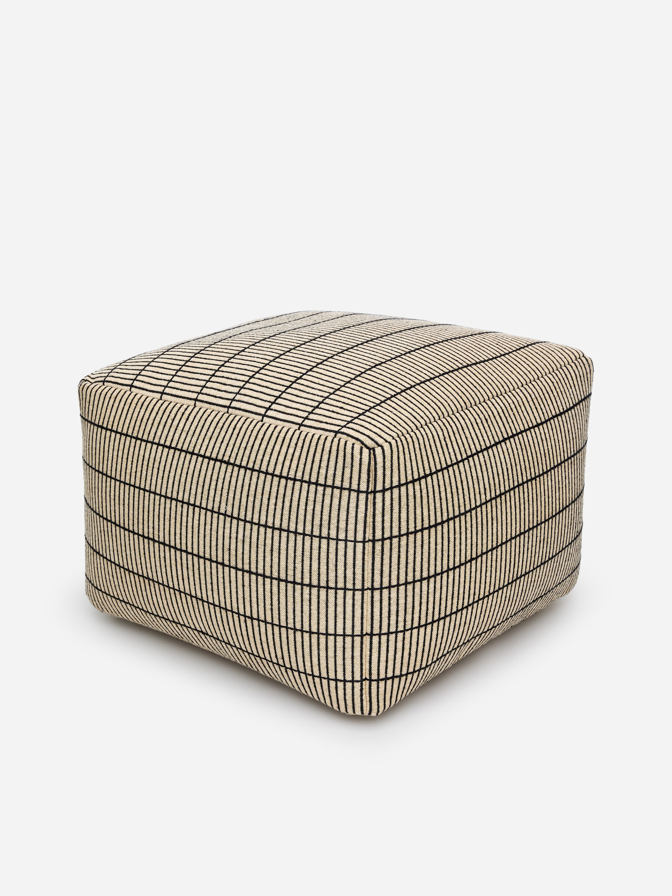 A beige square ottoman with a black grid pattern on a white background.