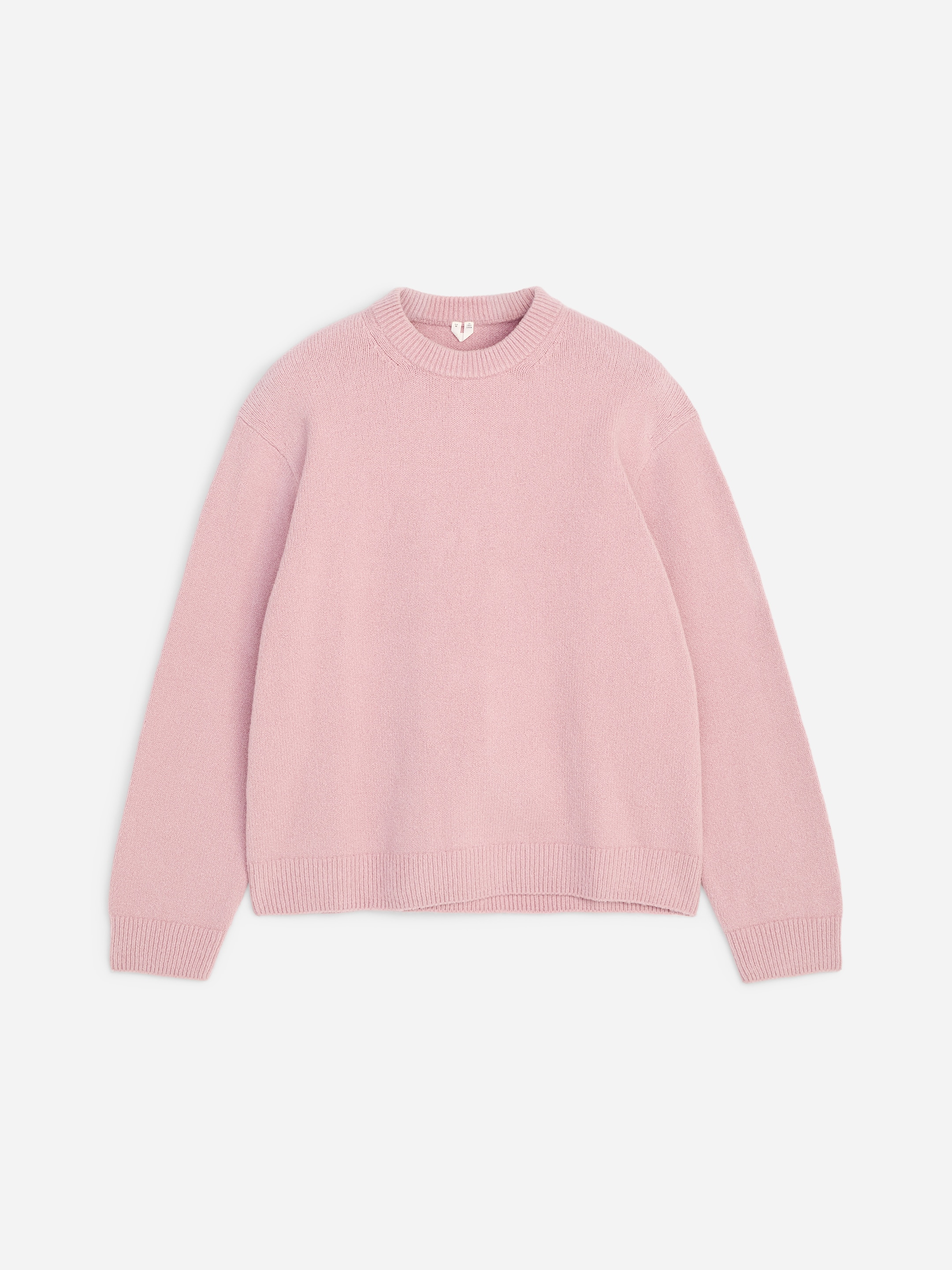 Light pink sweater with long sleeves and a ribbed crew neckline, shown on a plain white background.