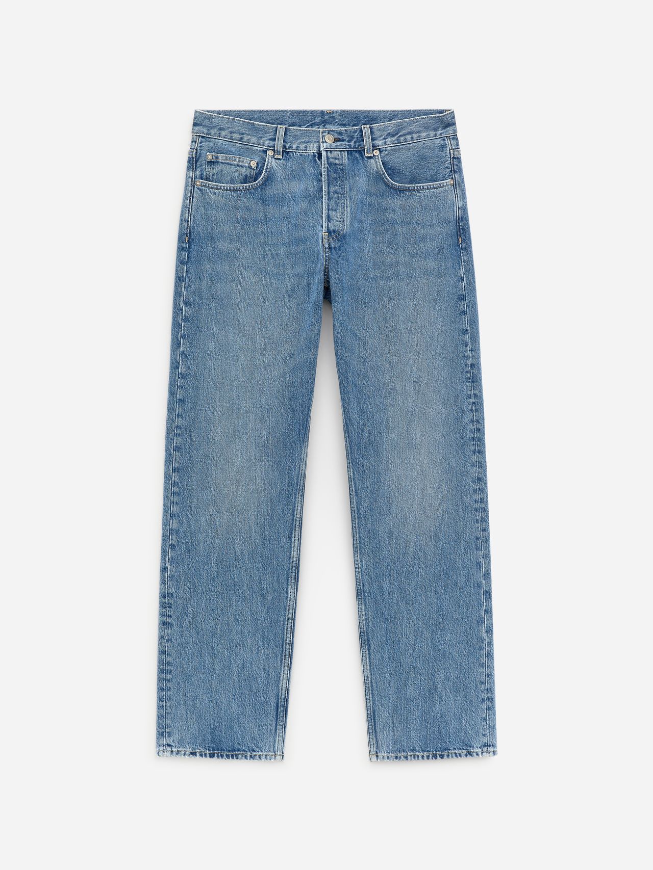 A pair of straight-leg blue jeans with a classic five-pocket design, light fading, and a button-fly closure, laid flat on a white background.