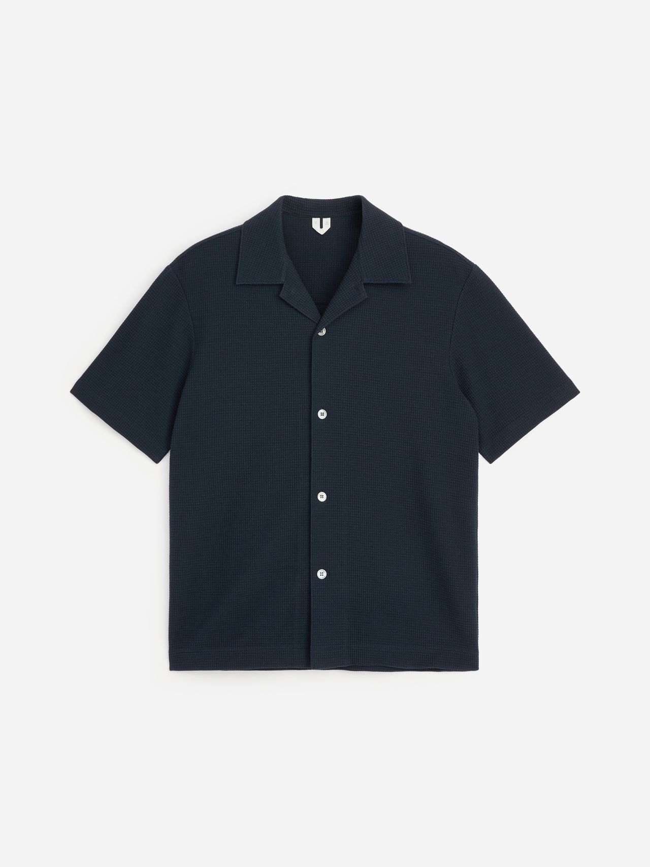Navy blue short-sleeve shirt with a textured pattern and button-down front, neatly laid flat on a white background.