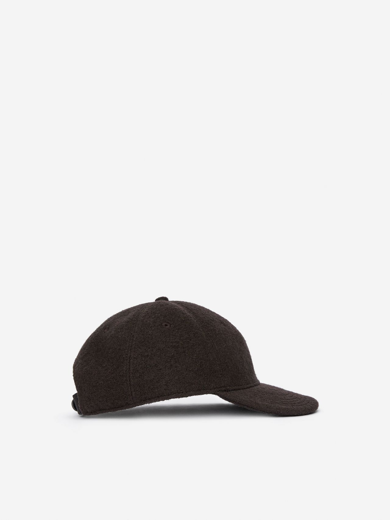 Dark brown baseball cap with a curved brim, side view. The cap has a textured fabric and an adjustable strap at the back.
