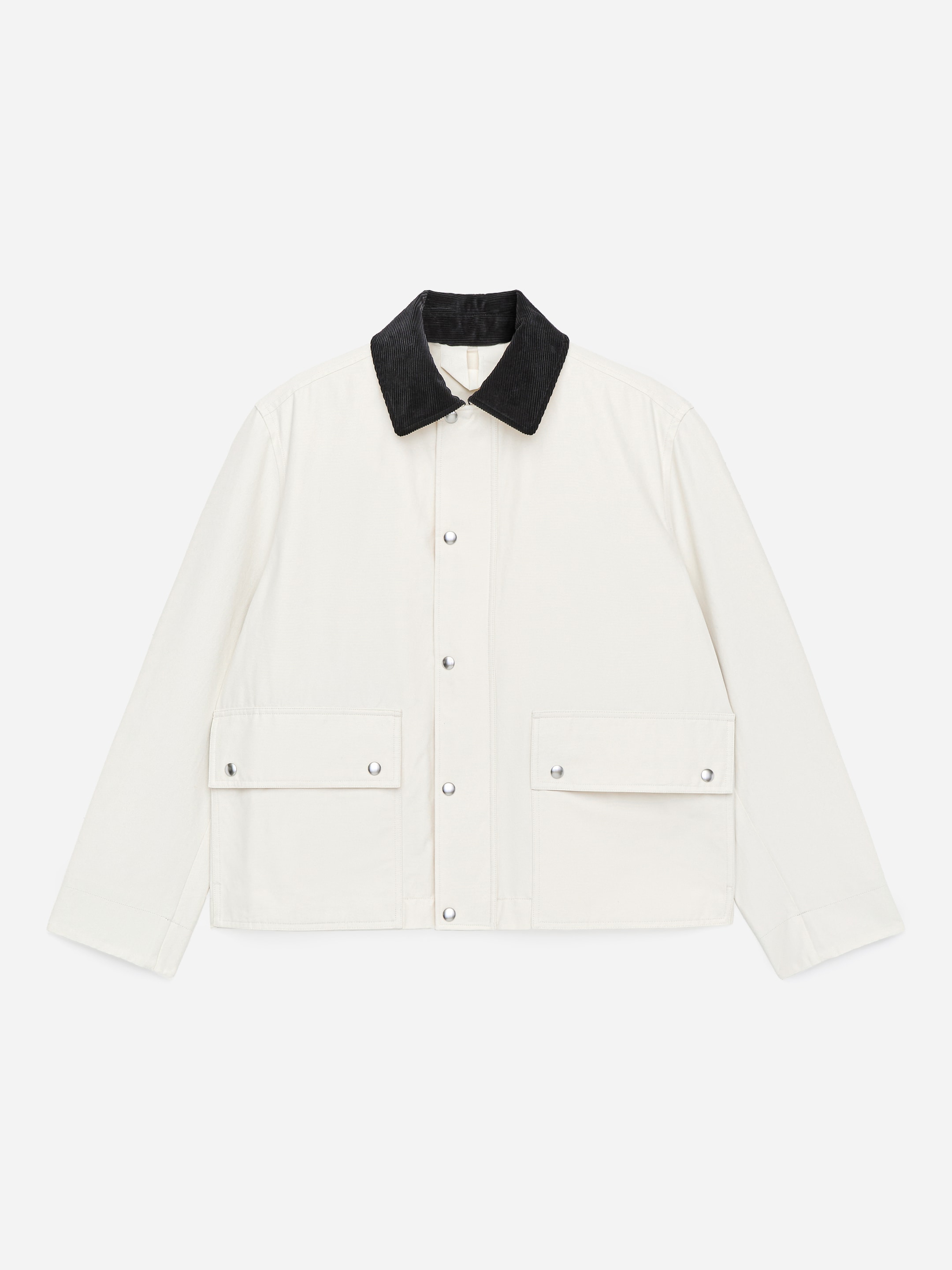 A cream-colored jacket with a black collar, snap buttons, and two front flap pockets.