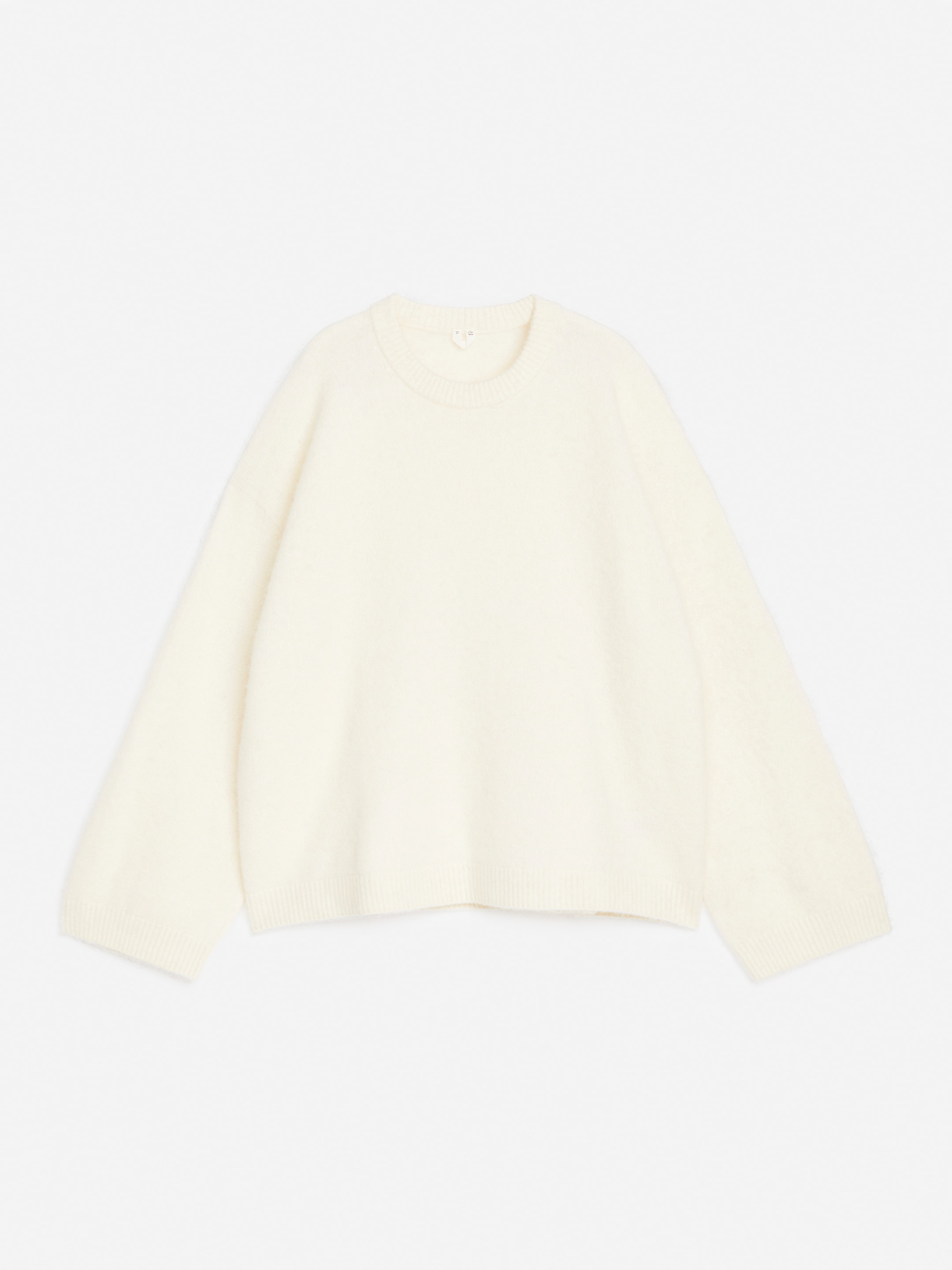 A white, long-sleeved, crew-neck sweater on a plain white background.