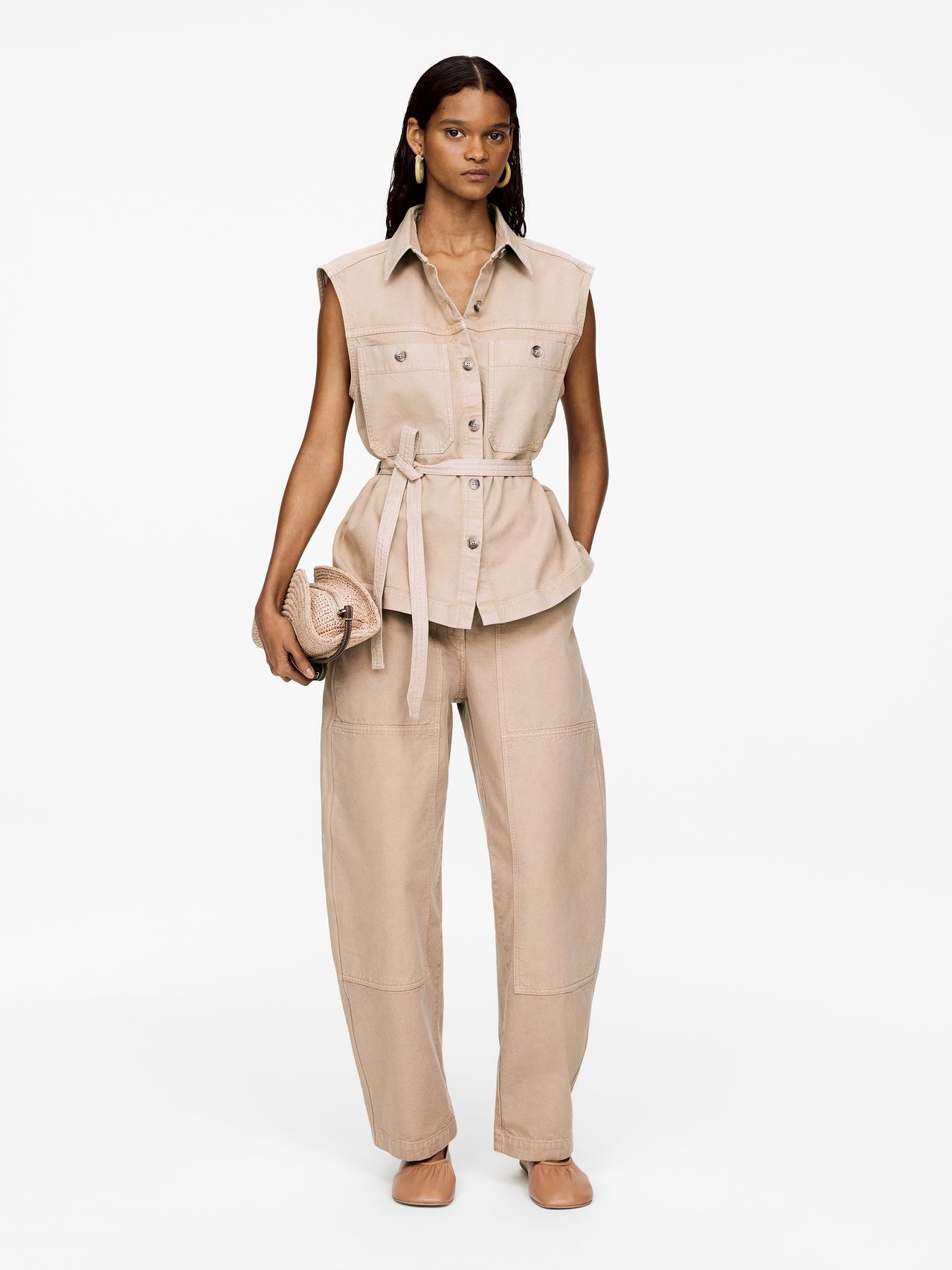 Woman in beige against white background