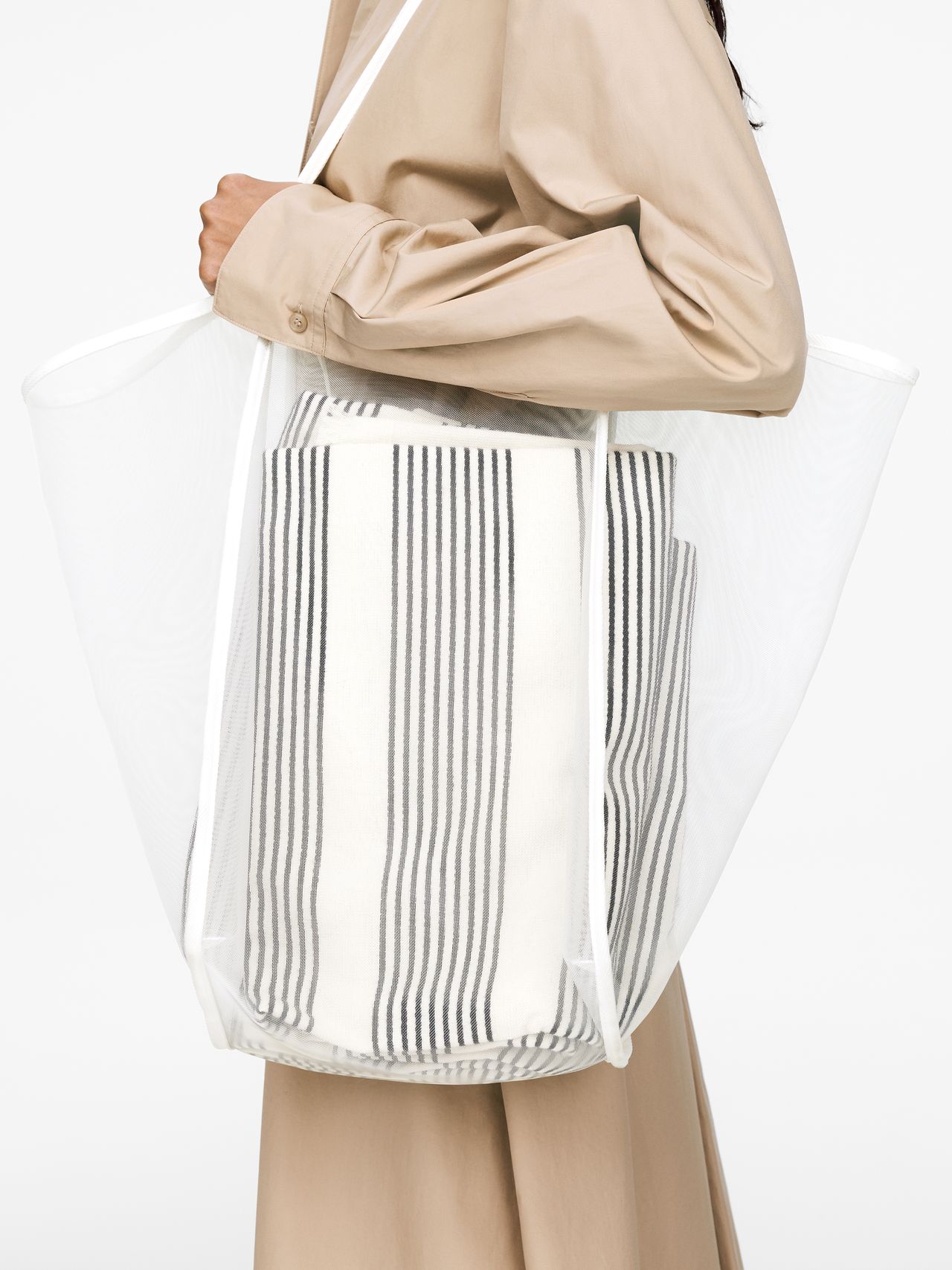 Close up, woman holding white net bag