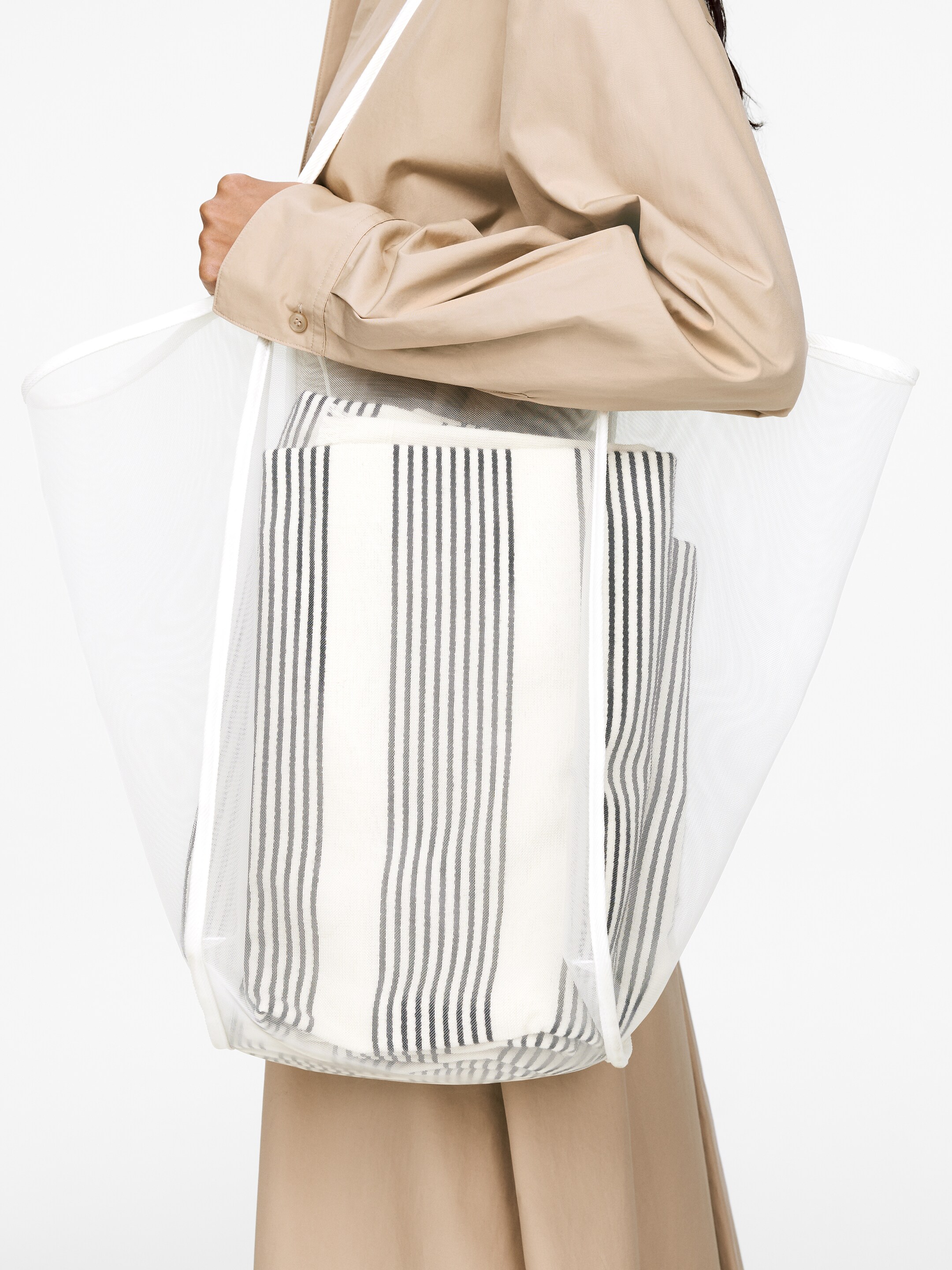 Close up, woman holding white net bag