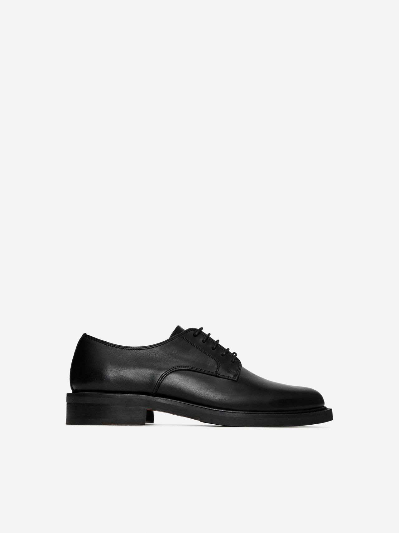 Black leather dress shoe with a low heel and lace-up design, displayed on a plain white background.