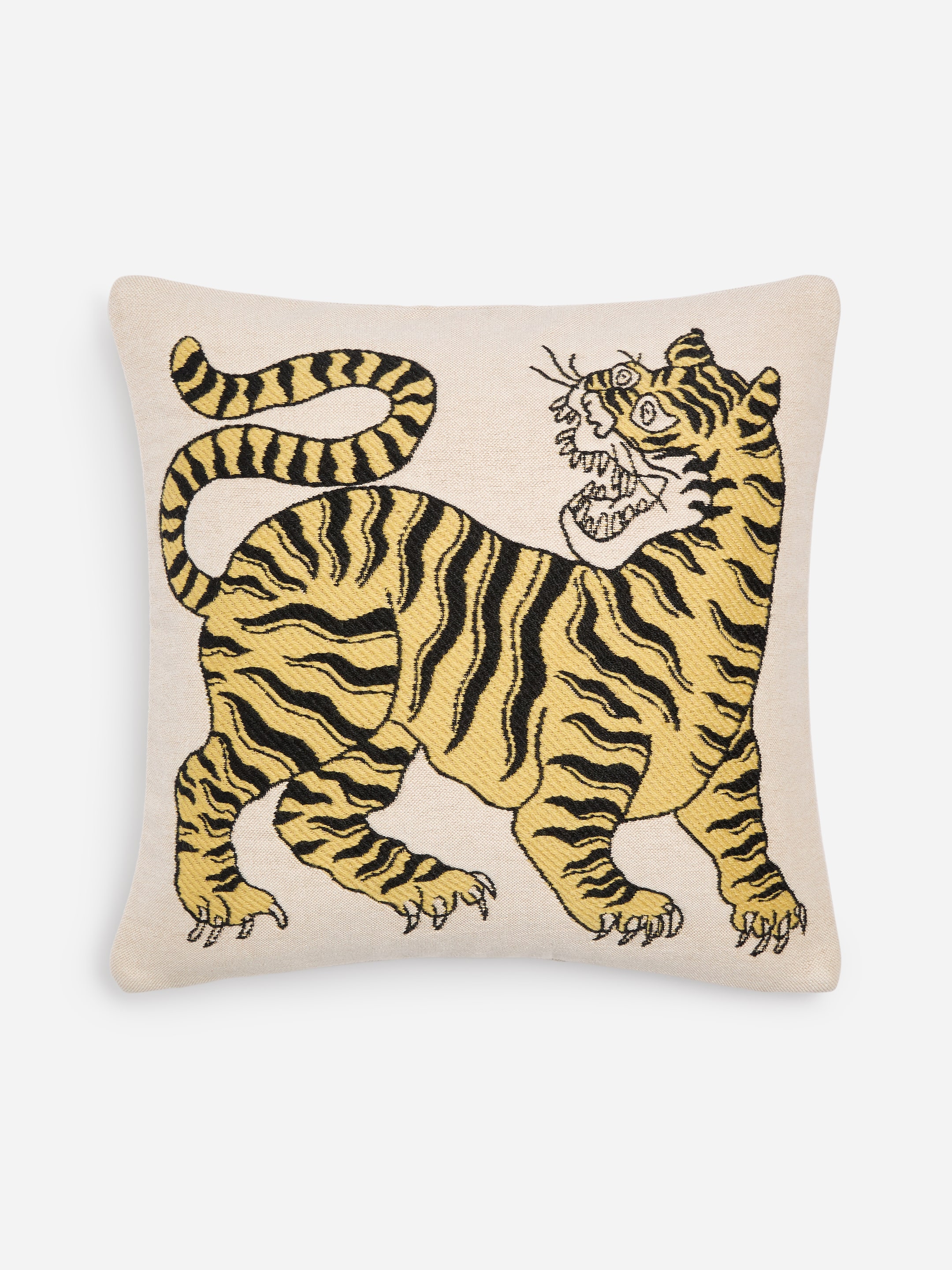 A cushion with an illustration of a tiger, featuring bold yellow and black stripes and an expressive face, set against a plain beige background.