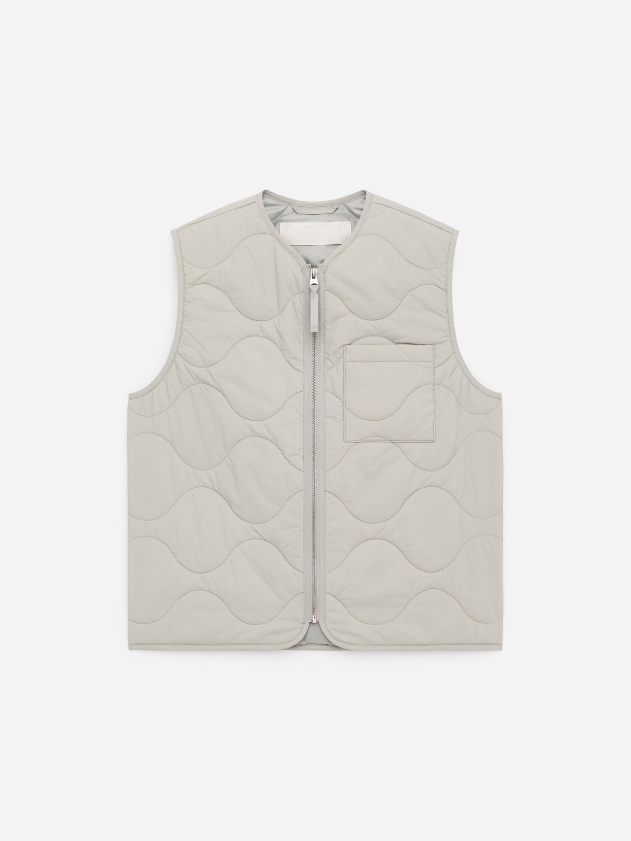 A light gray quilted vest with a wavy pattern, featuring a front zipper and a chest pocket, displayed on a plain white background.