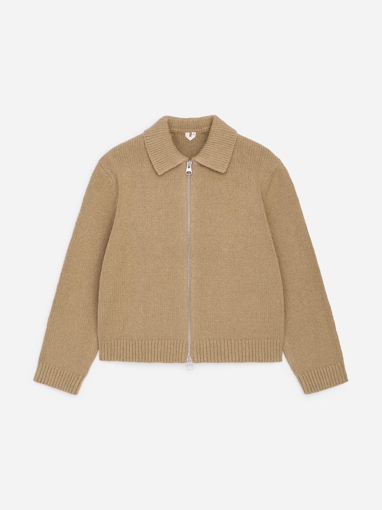 Beige knitted cardigan with a pointed collar and front zipper closure, featuring ribbed cuffs and hem, laid flat on a white background.