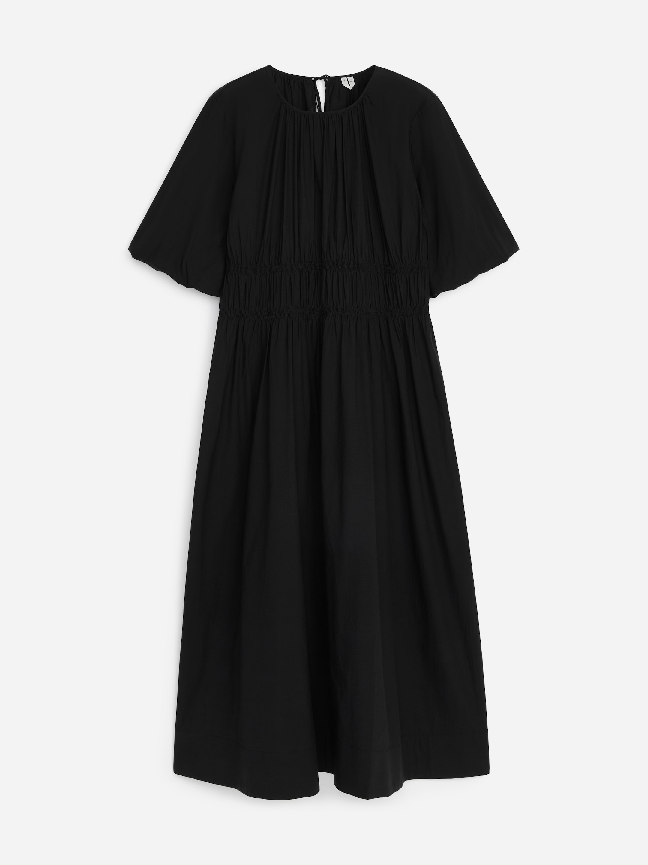 Black dress with short sleeves, a round neckline, and smocked detailing, hanging against a white background.