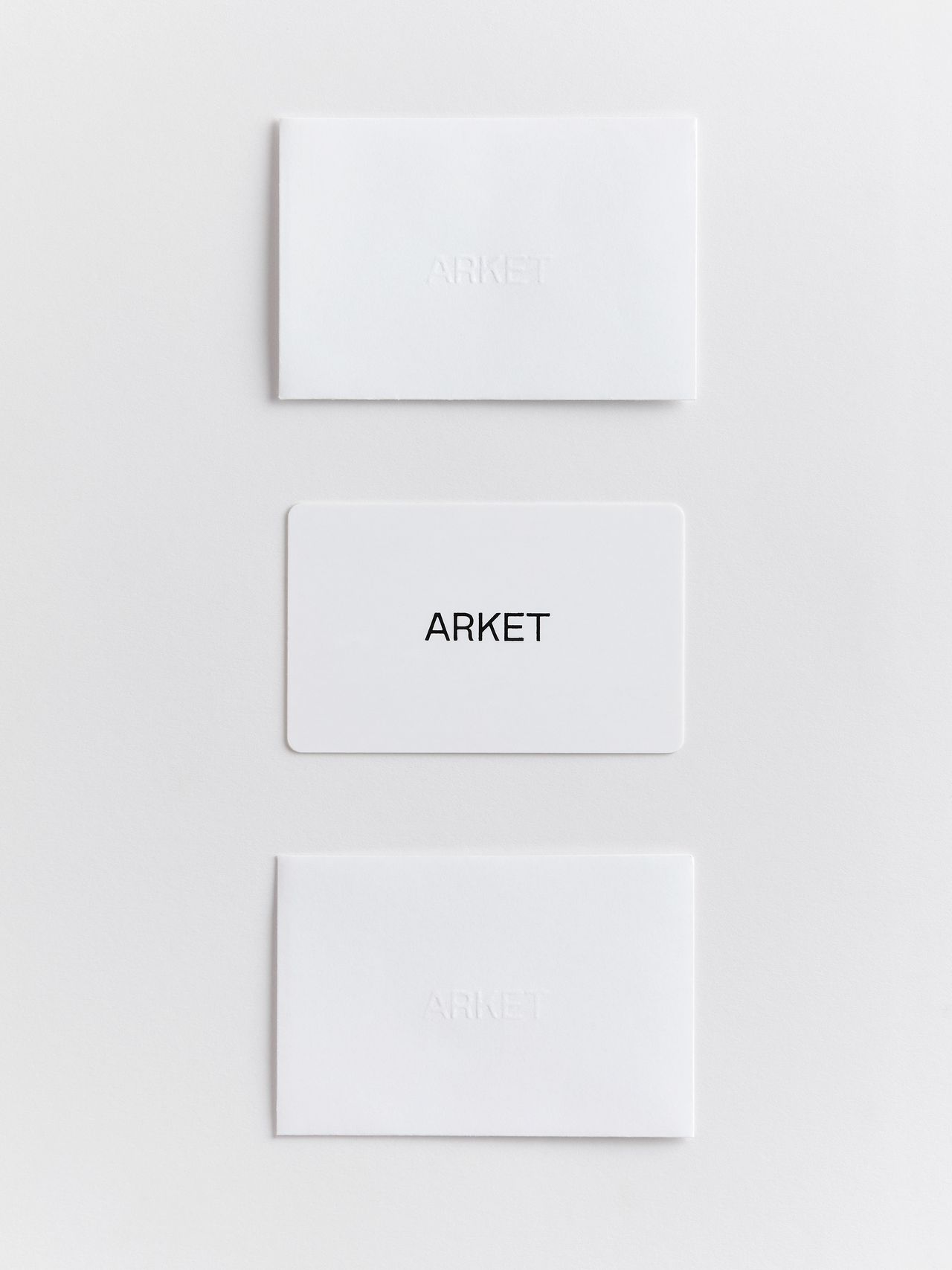 Three white cards on a white background, with the middle card displaying the word "ARKET" in black text.