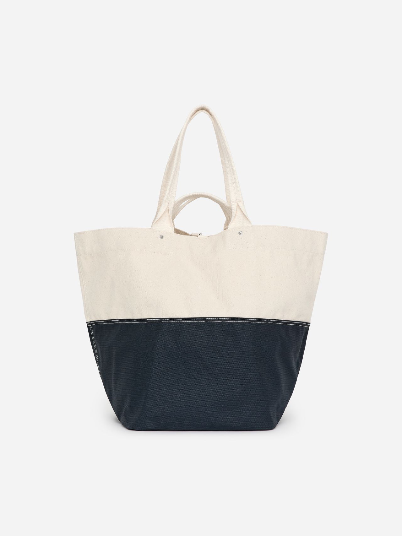 Two-tone tote bag with long handles; upper half in beige, bottom half in navy blue, on a white background.
