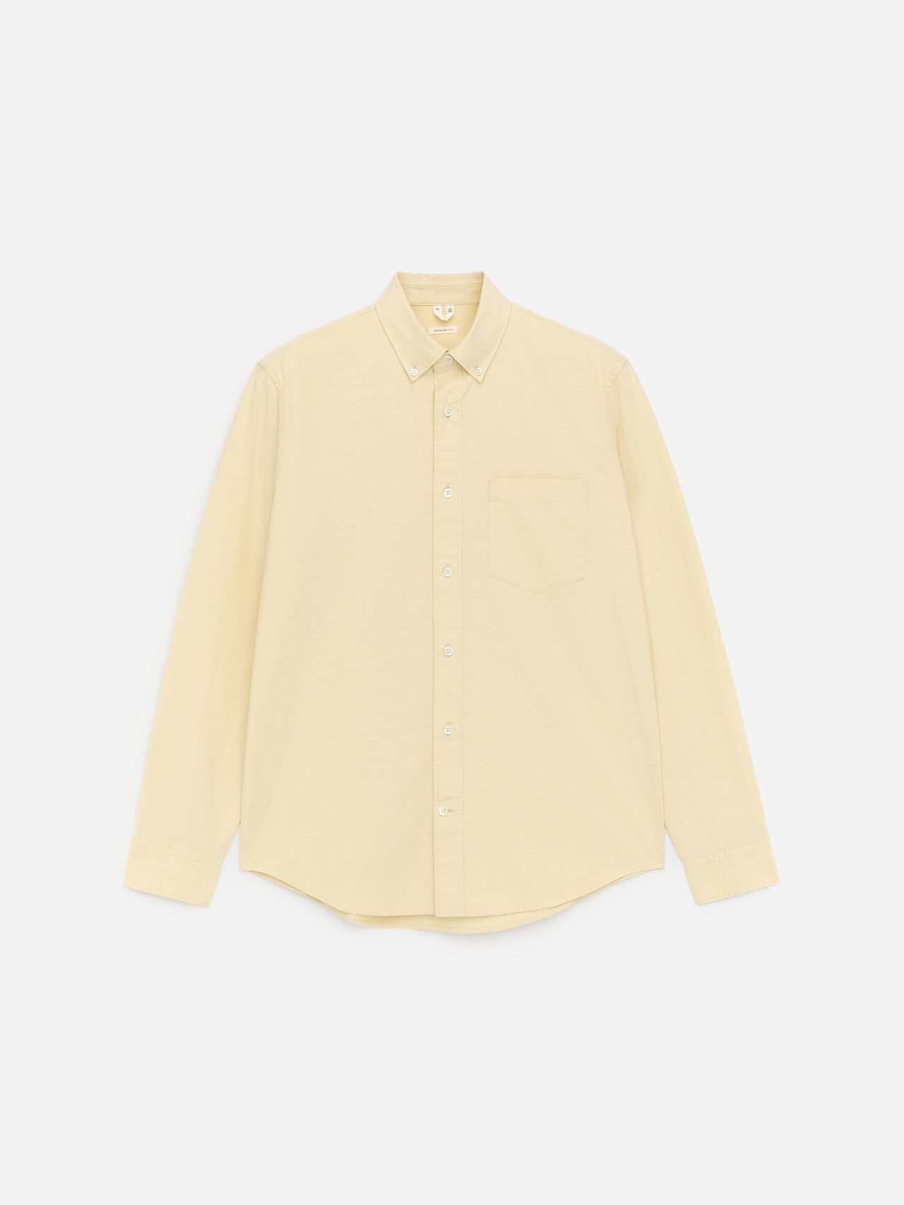 A beige button-up shirt with long sleeves and a chest pocket, displayed on a plain white background.