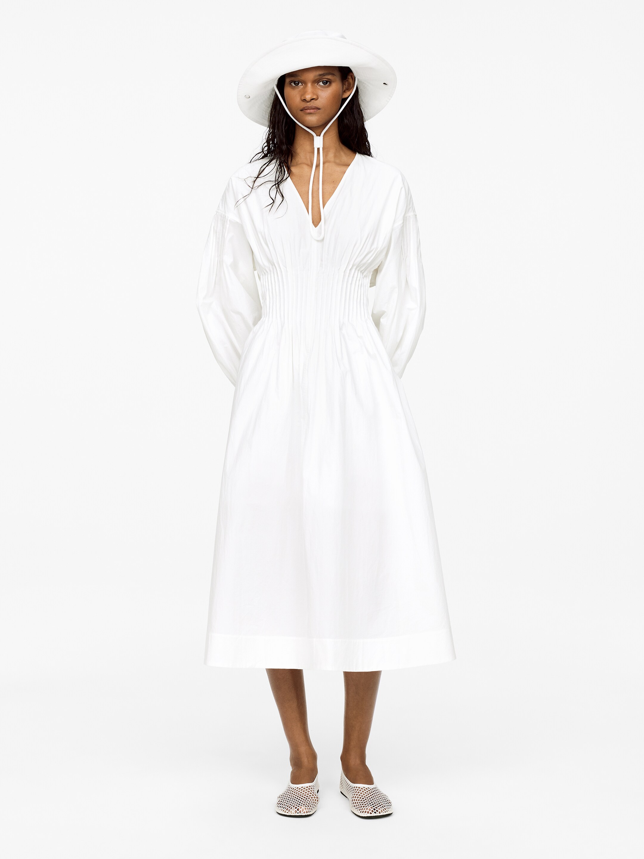Woman in white dress and hat