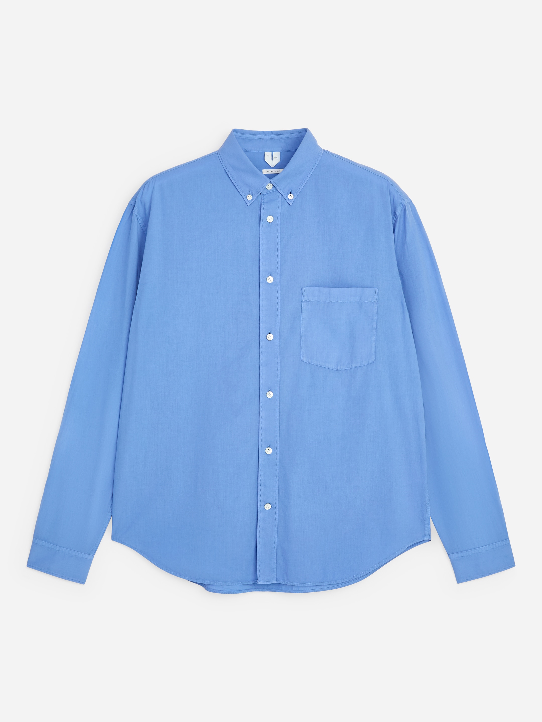 Light blue long-sleeve button-up shirt with a front pocket, featuring a classic collar and white buttons, laid flat on a white background.