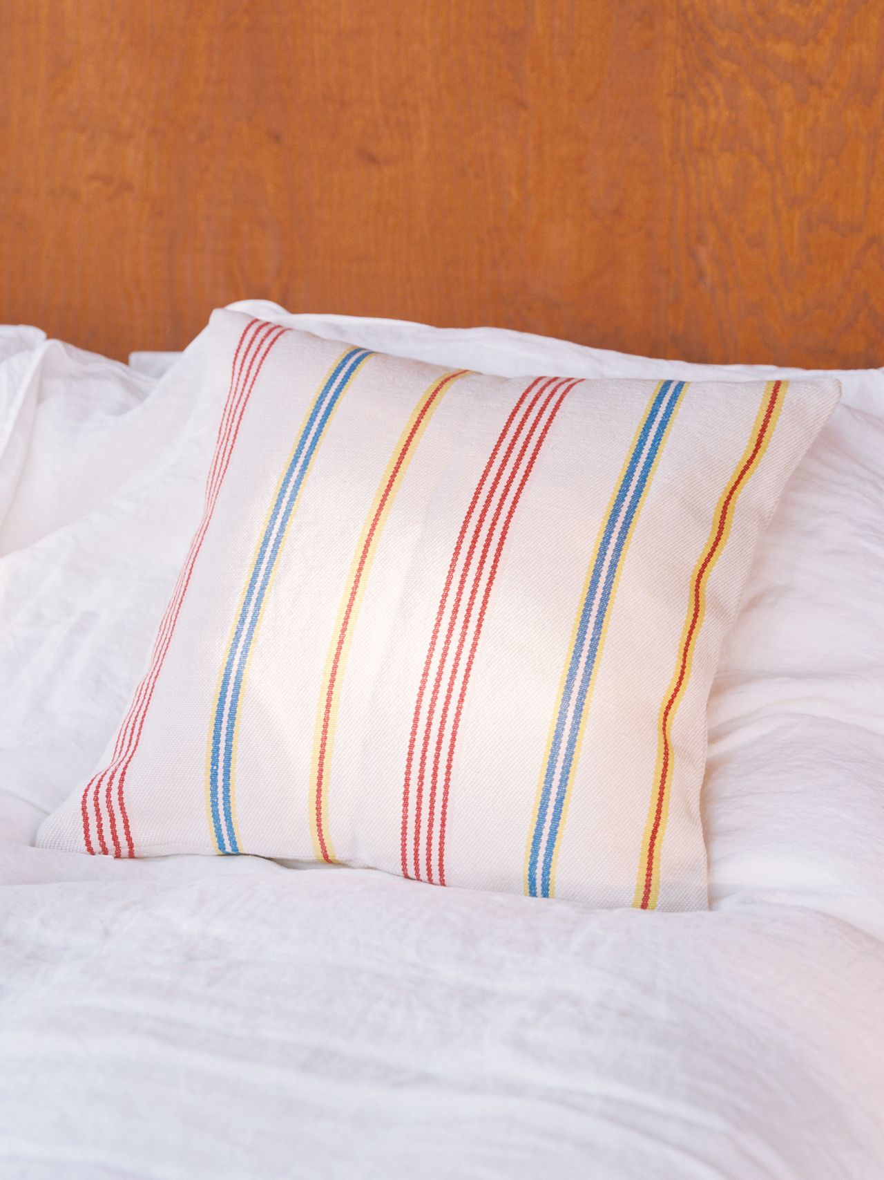 Pillow with stripes on a bed