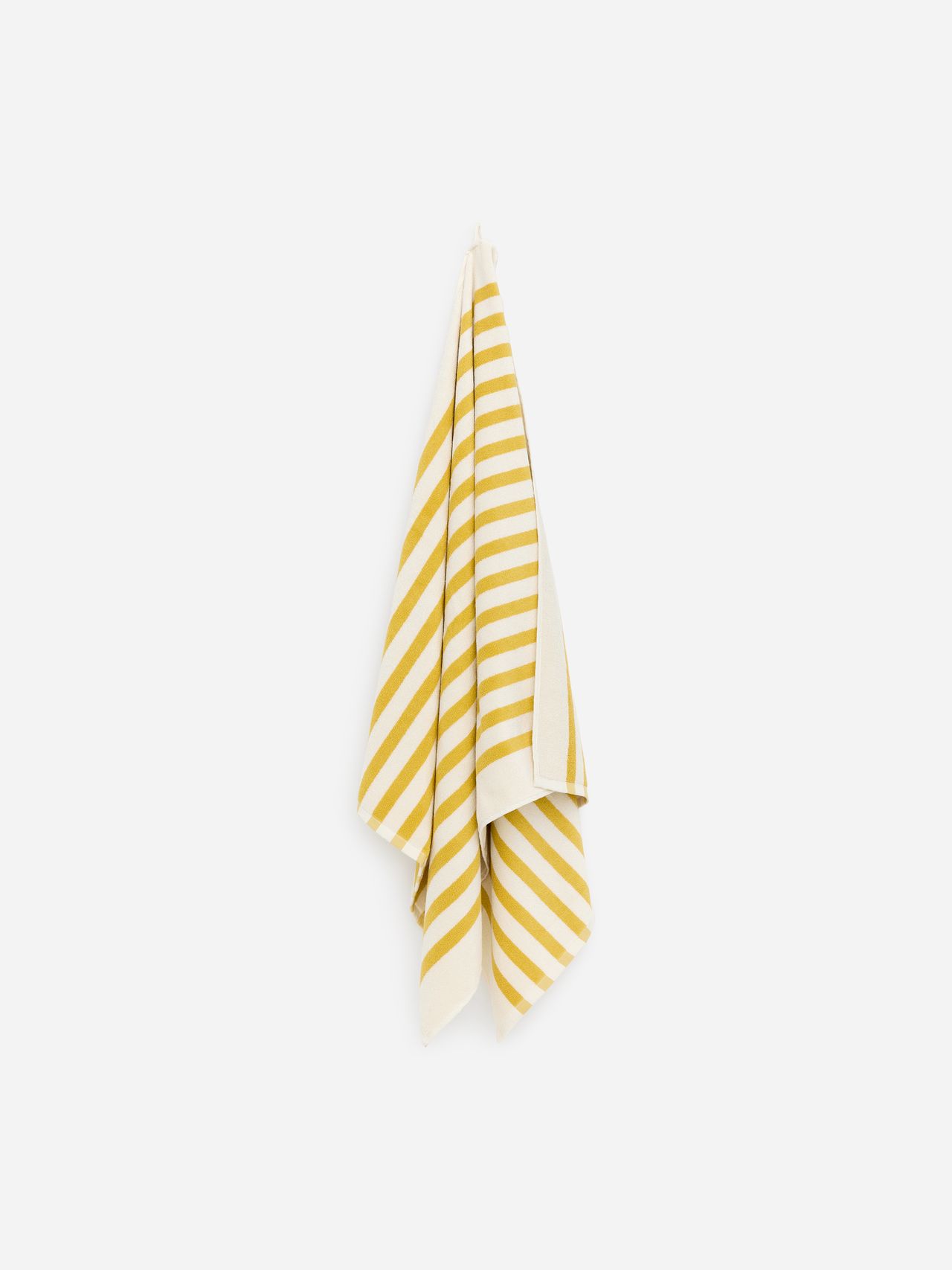 A yellow and white striped towel hanging on a wall in a vertical arrangement against a plain background.
