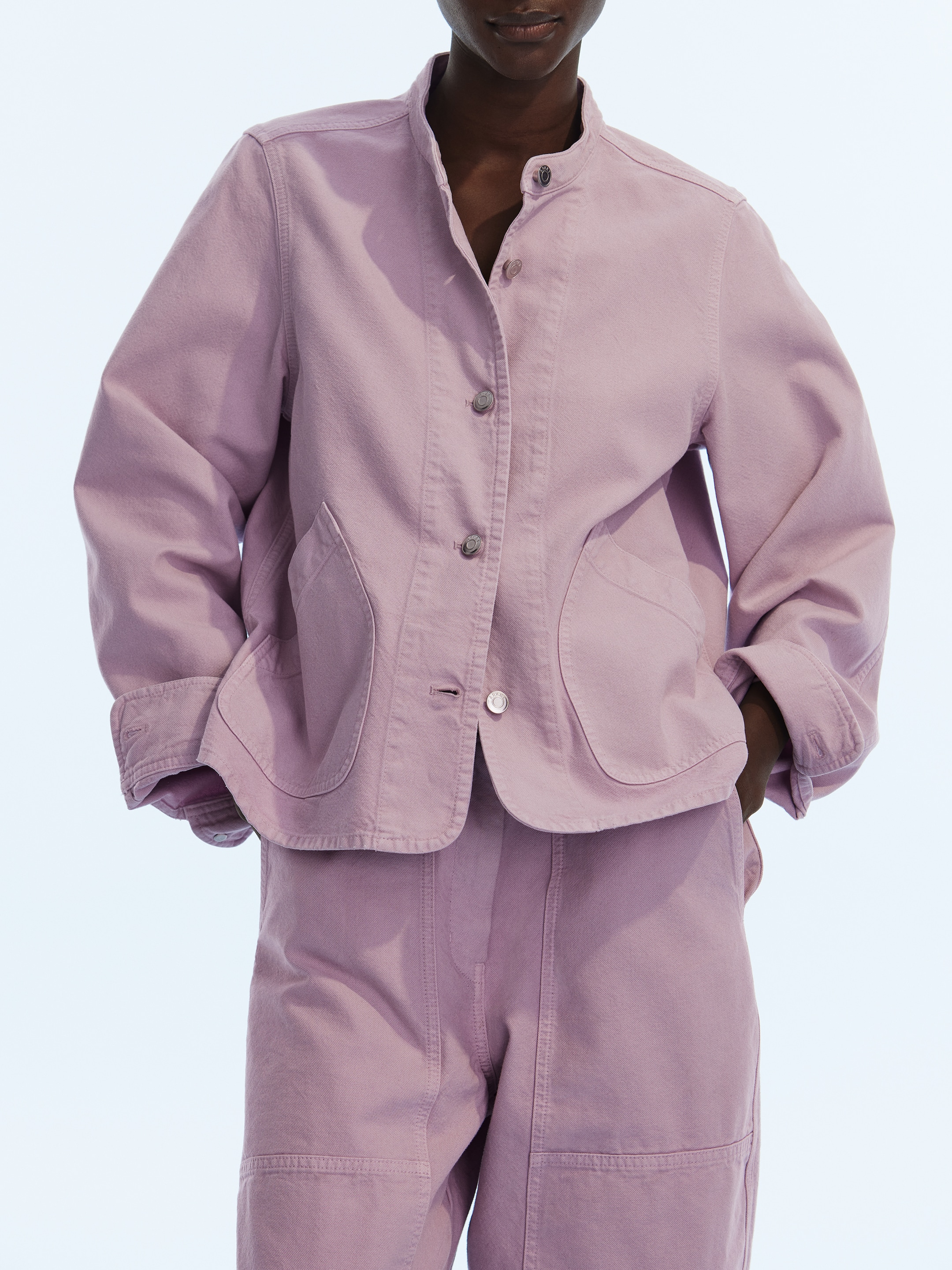 Woman in light purple jacket and pants