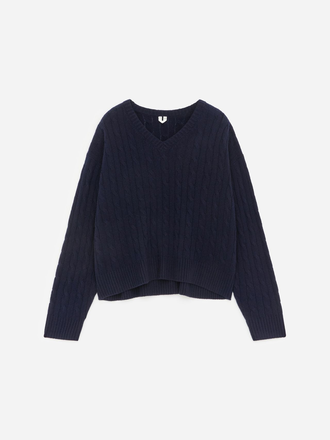 Navy blue V-neck cable knit sweater with long sleeves against a white background.