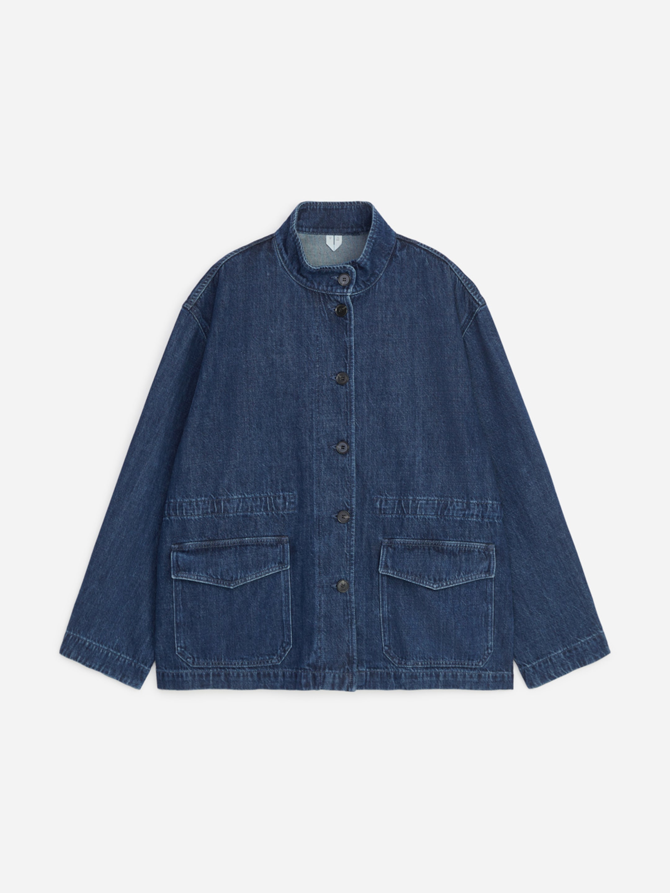 A relaxed-fit denim jacket with a high collar, five buttons down the front, and two large pockets. The material appears soft and well-worn.