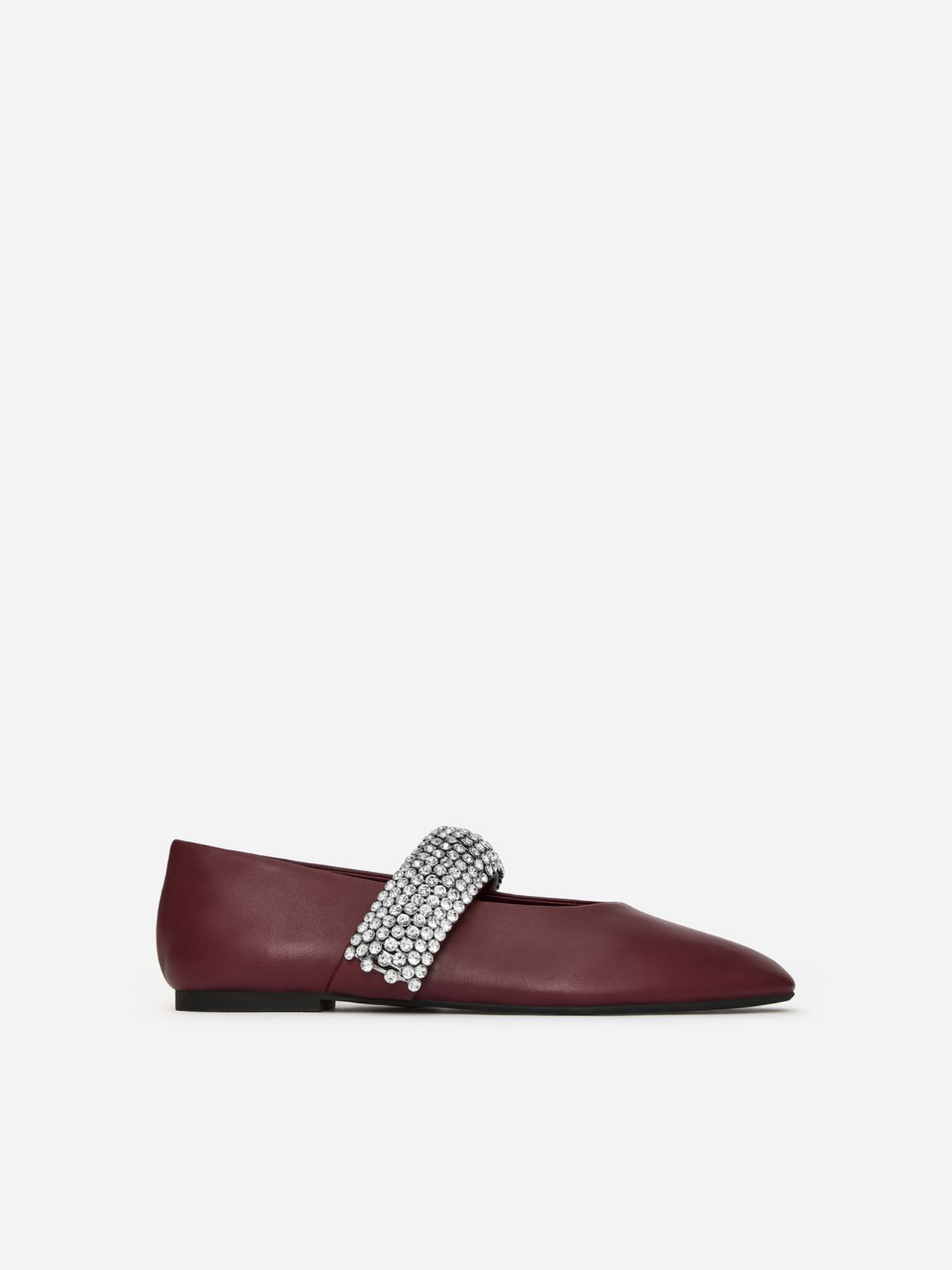 Maroon leather flat shoe with a sparkling rhinestone strap across the top, set against a plain white background.