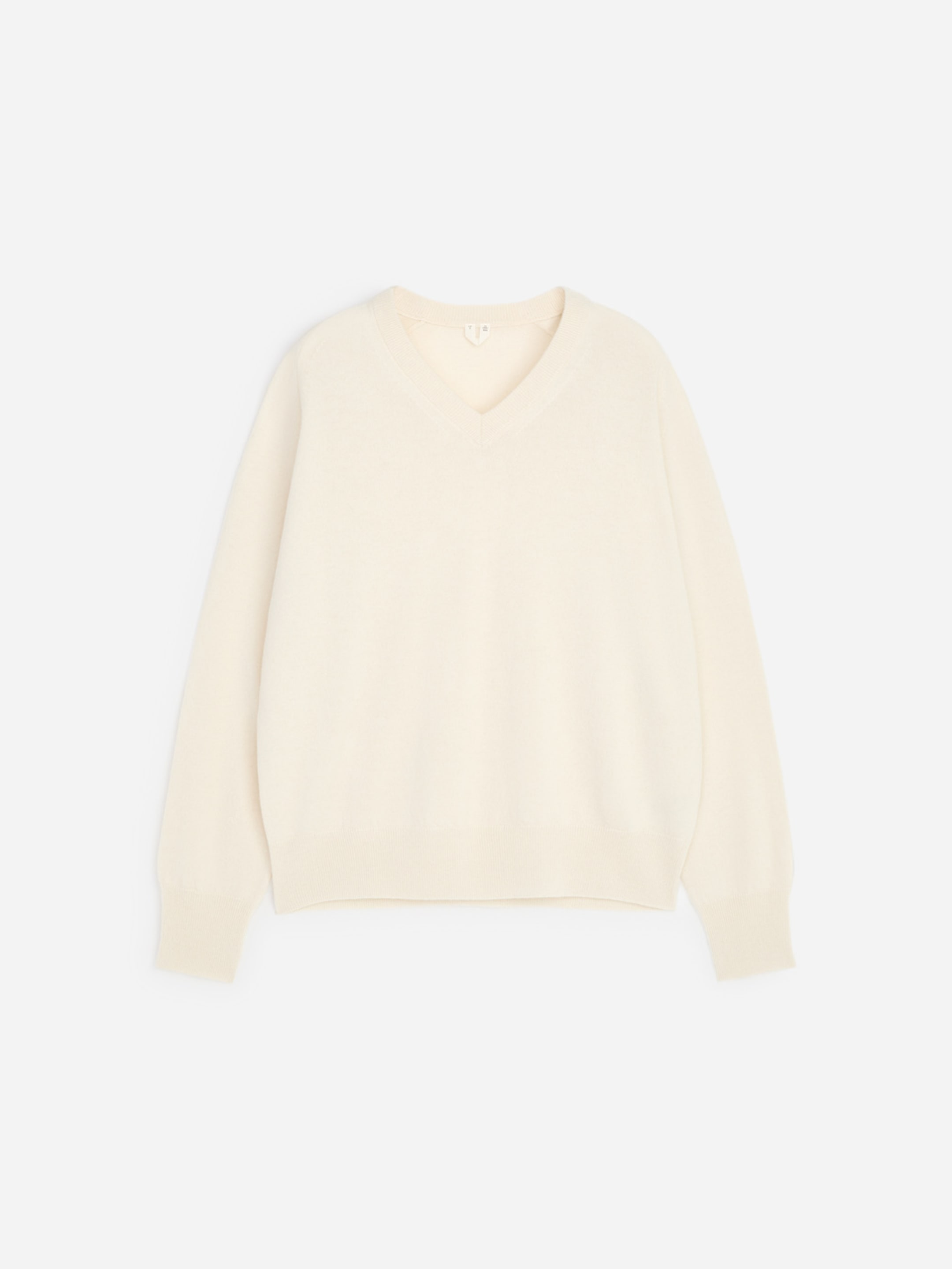 Off-white V-neck sweater with long sleeves and ribbed cuffs and hem, displayed on a plain light background.