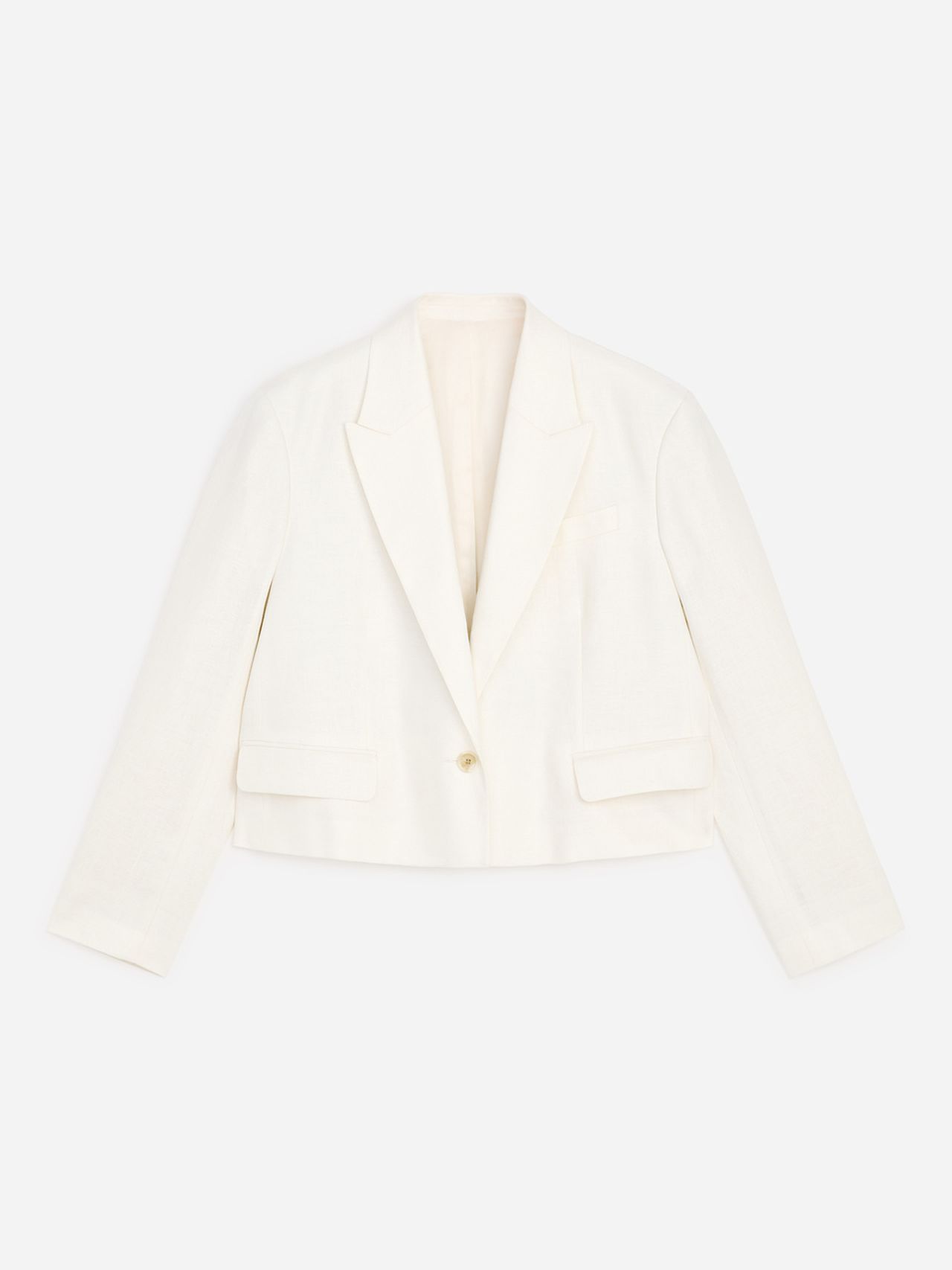 White cropped blazer with notched lapels, long sleeves, single button closure, and two flap pockets.