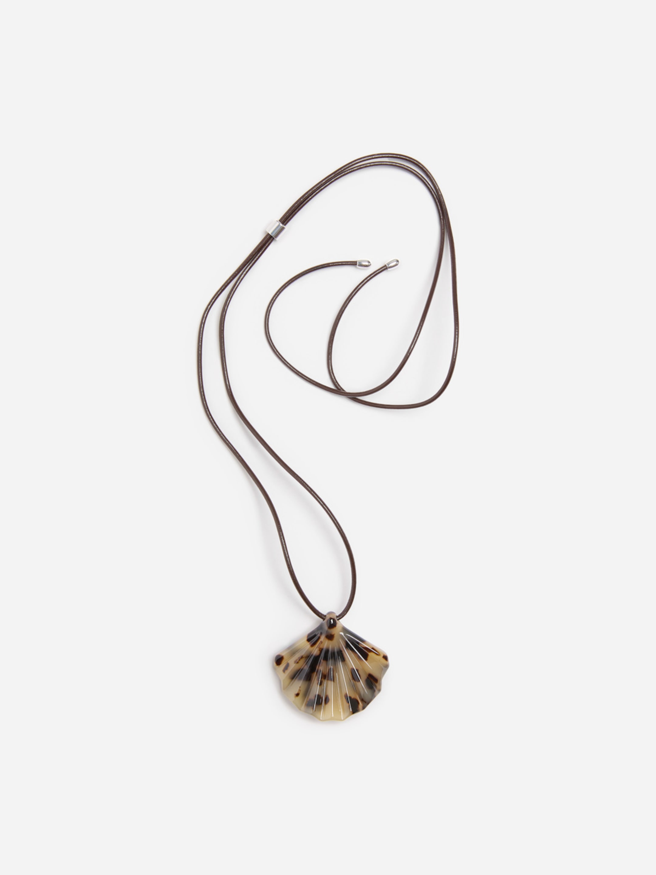 A brown cord necklace with a scallop-shaped, tortoiseshell pendant against a white background.