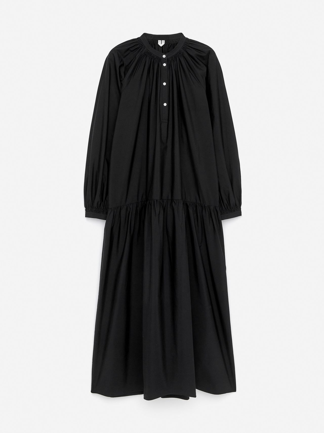Long black dress with a gathered neckline, buttoned front, and a tiered skirt. It features long sleeves and a loose, flowing silhouette.