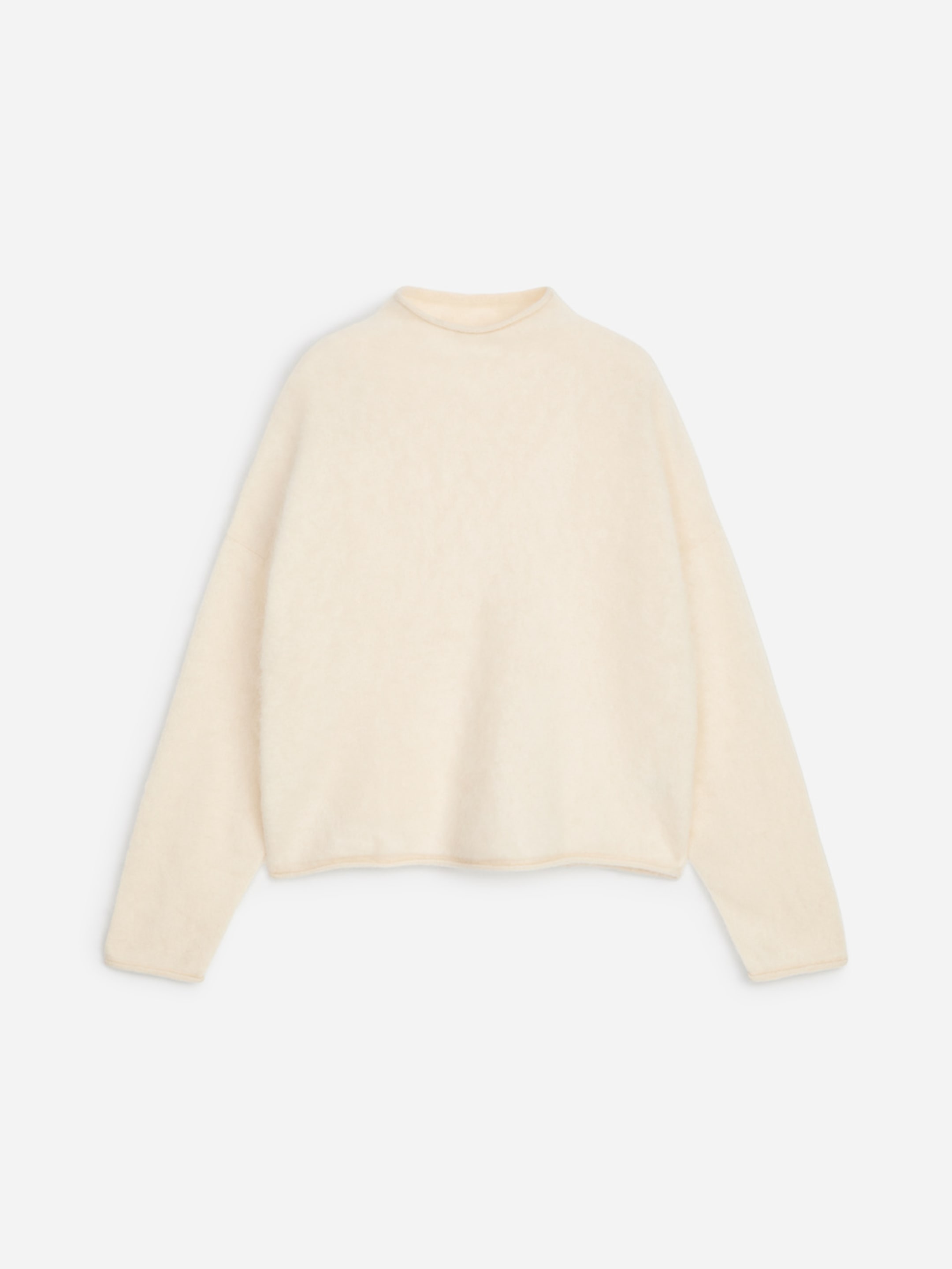 Cream-colored, long-sleeve sweater with a high neckline, laid flat on a white background.