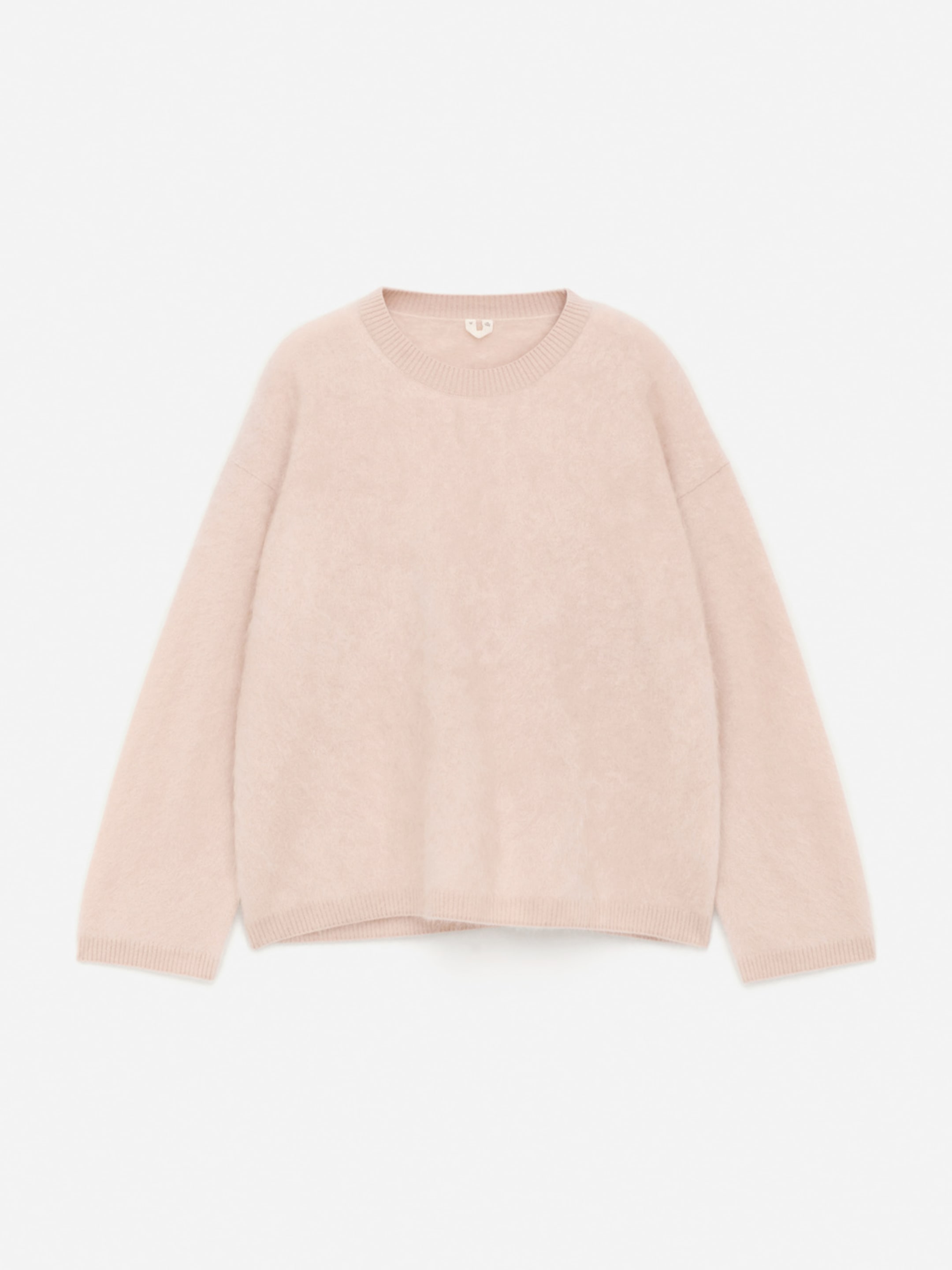 A soft, light pink fuzzy sweater with a round neckline and long sleeves, laid flat against a white background.