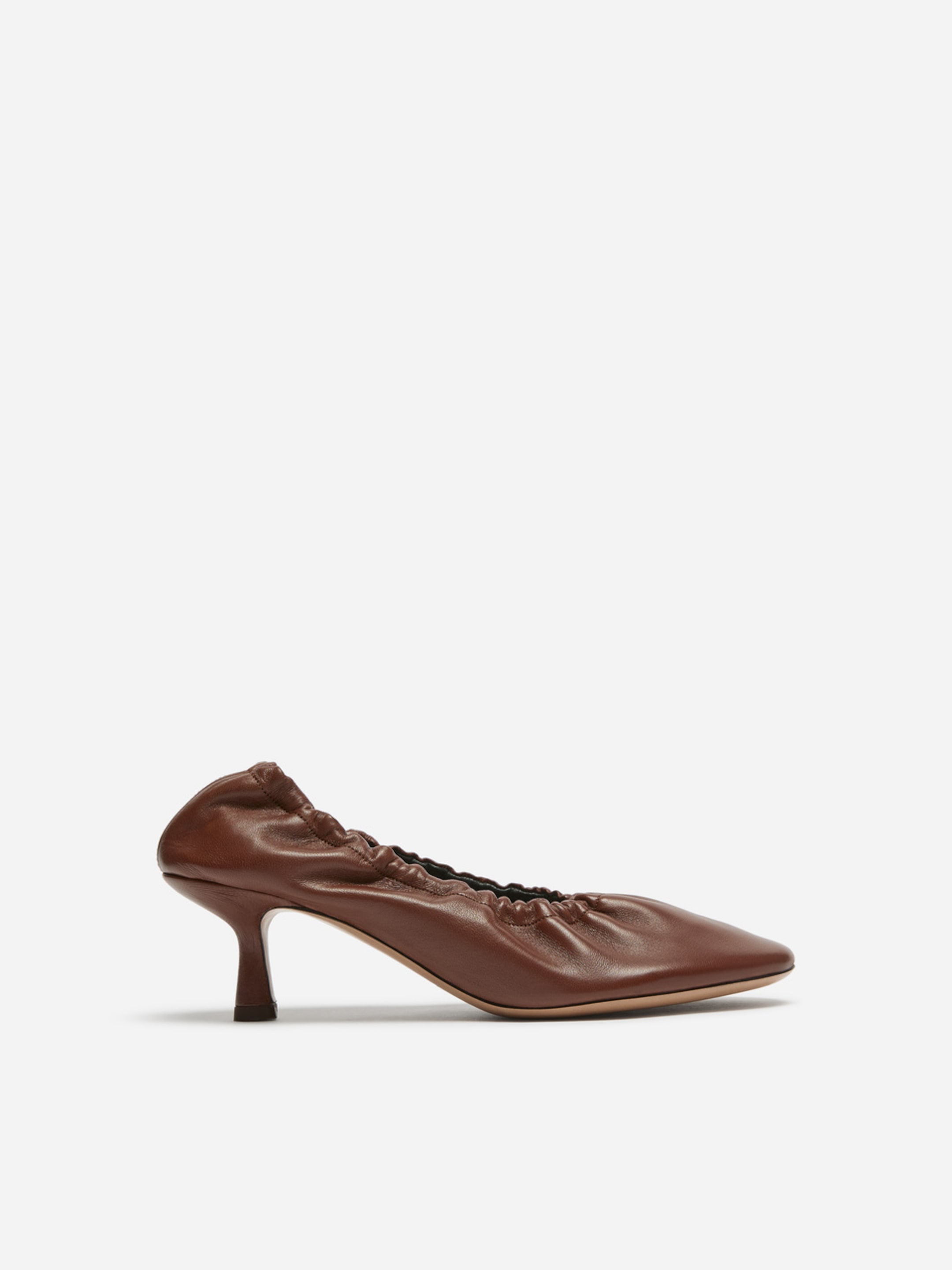 Brown leather pump with a ruched design, pointed toe, and slim heel, set against a white background.