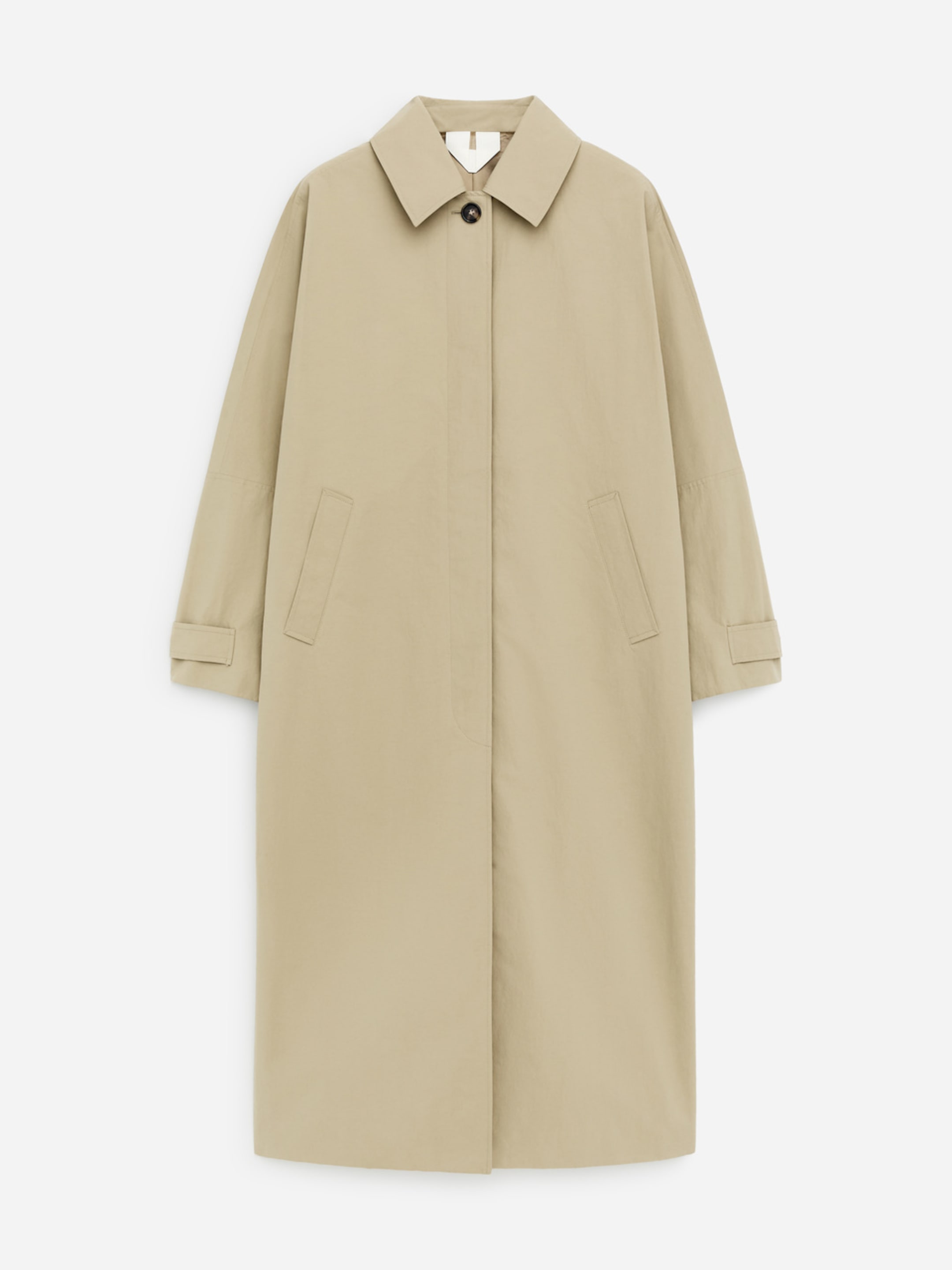A beige, long trench coat with a classic collar, button closure, and front pockets, displayed on a plain white background.