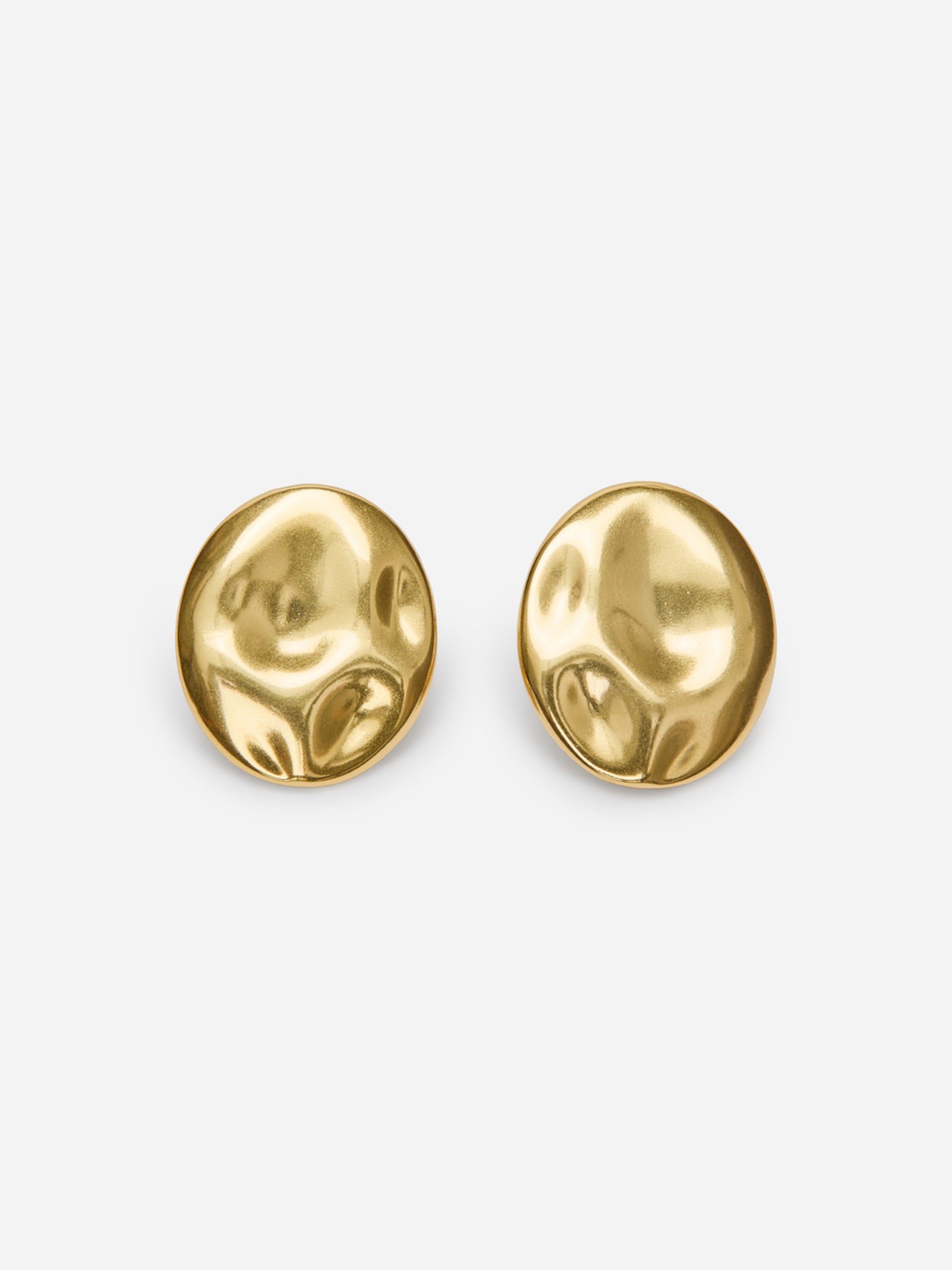 Two round, textured, gold-colored earrings against a plain white background.