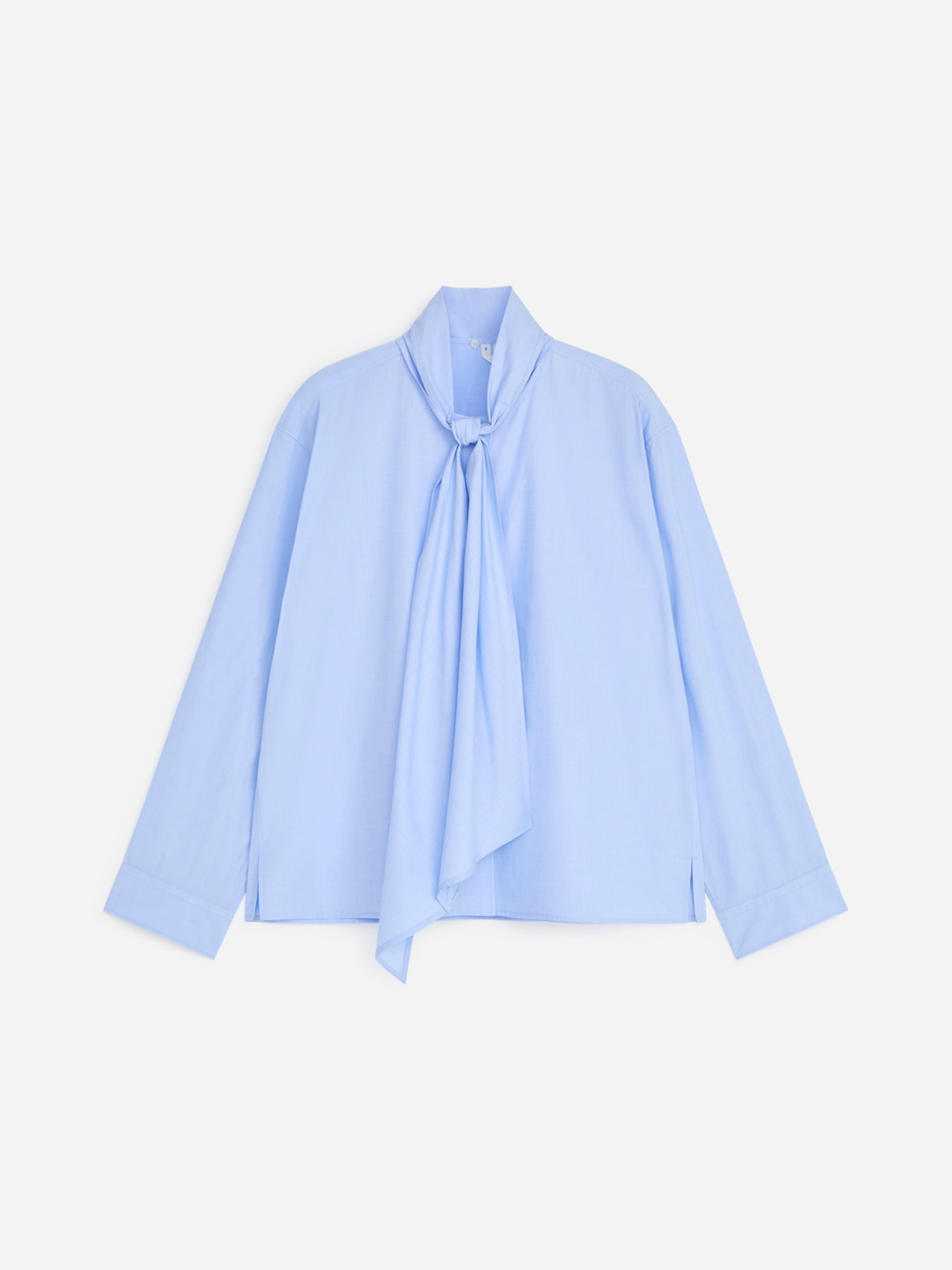 Light blue blouse with long sleeves and a tied bow at the neck, displayed against a plain white background.