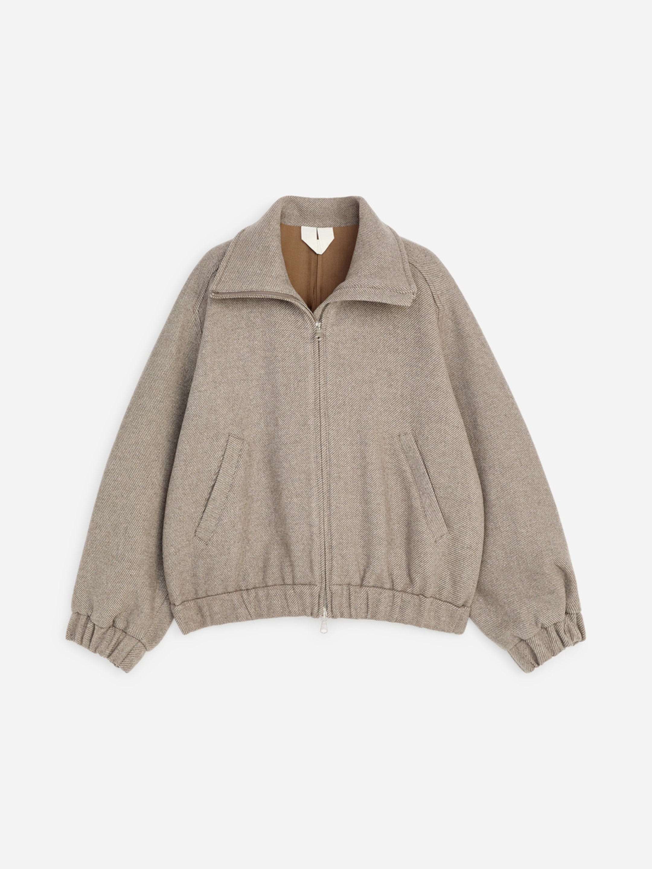 Beige zip-up jacket with a wide collar, elastic cuffs, and hem, featuring two front pockets.