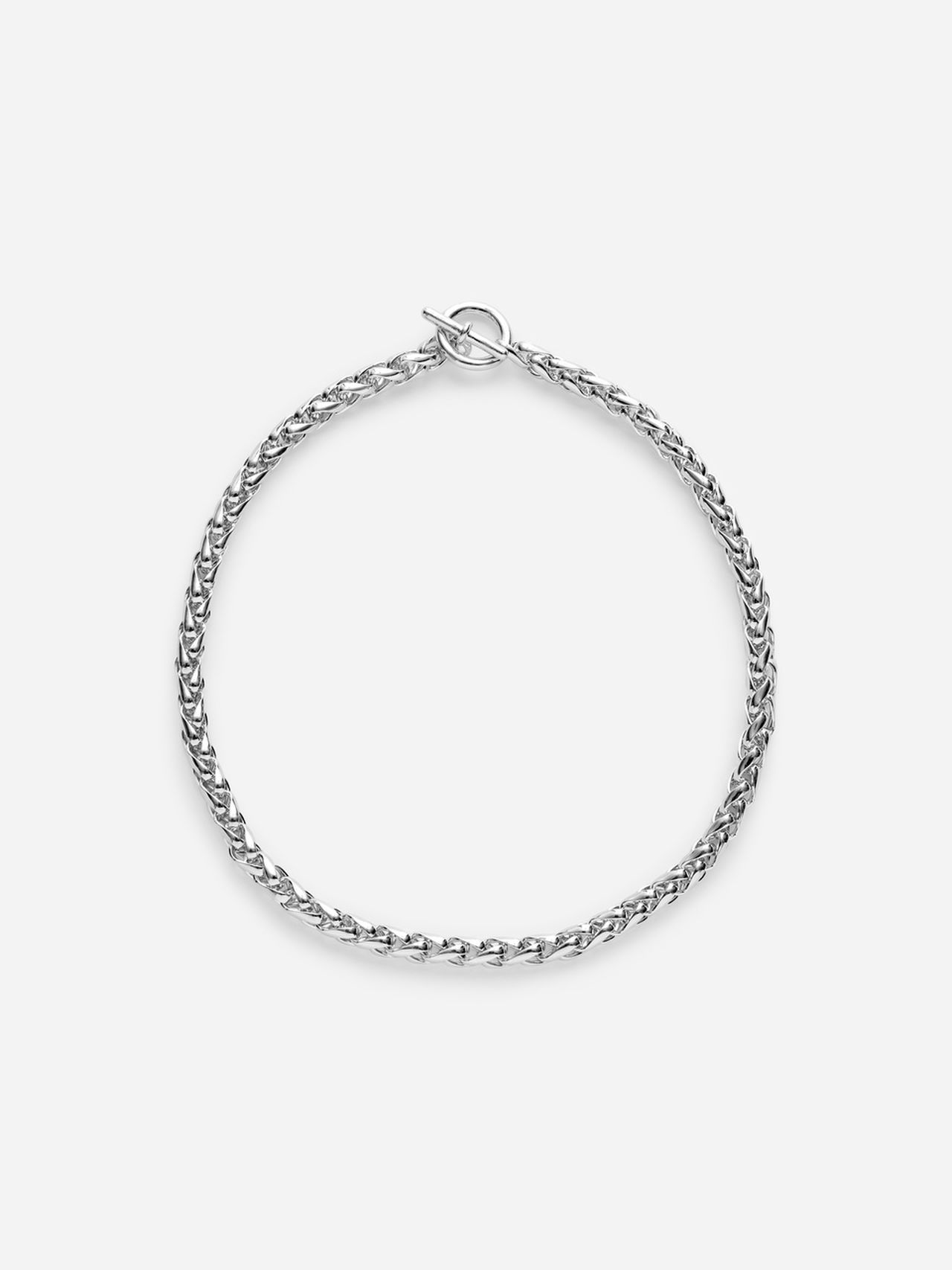 A simple silver chain bracelet featuring a toggle clasp, displayed on a white background.
