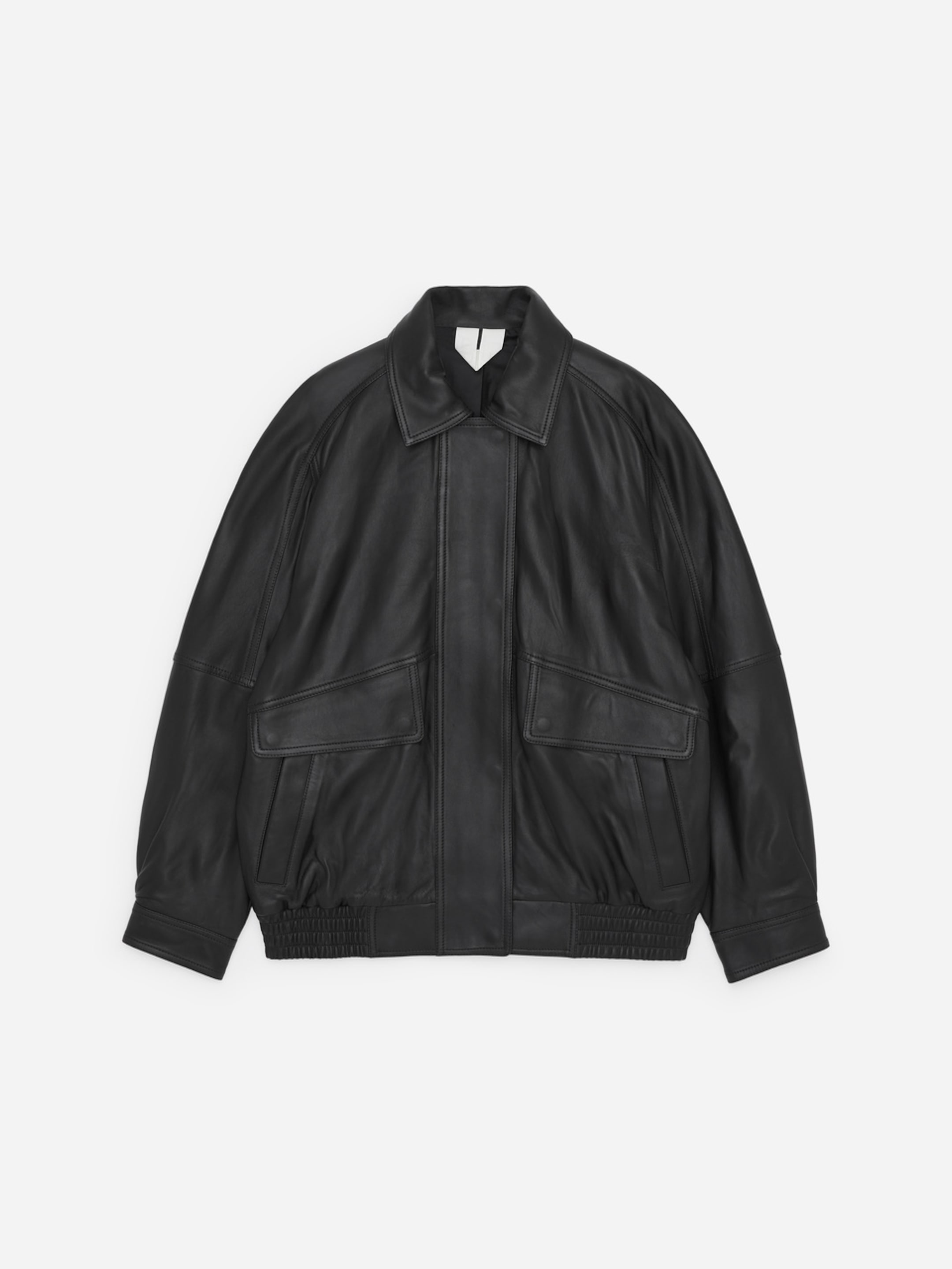 A black leather jacket with a collared neckline, large front pockets, and ribbed cuffs laid flat on a plain white background.