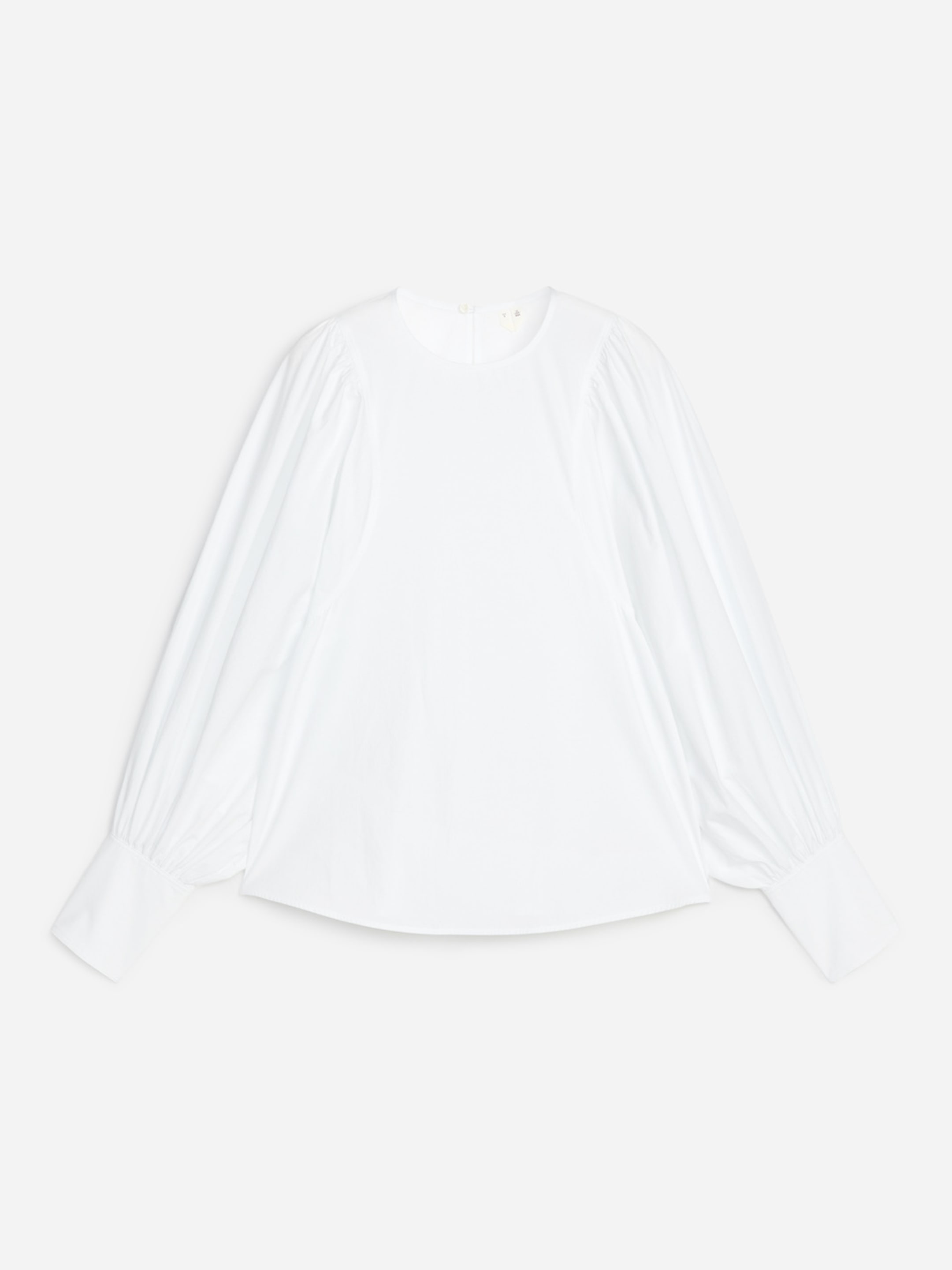 White long-sleeve blouse with puffed sleeves and wide cuffs, laid flat on a plain background.